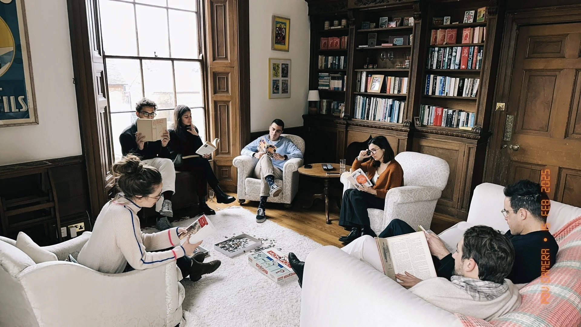 Informal group discussion in the country house  library 