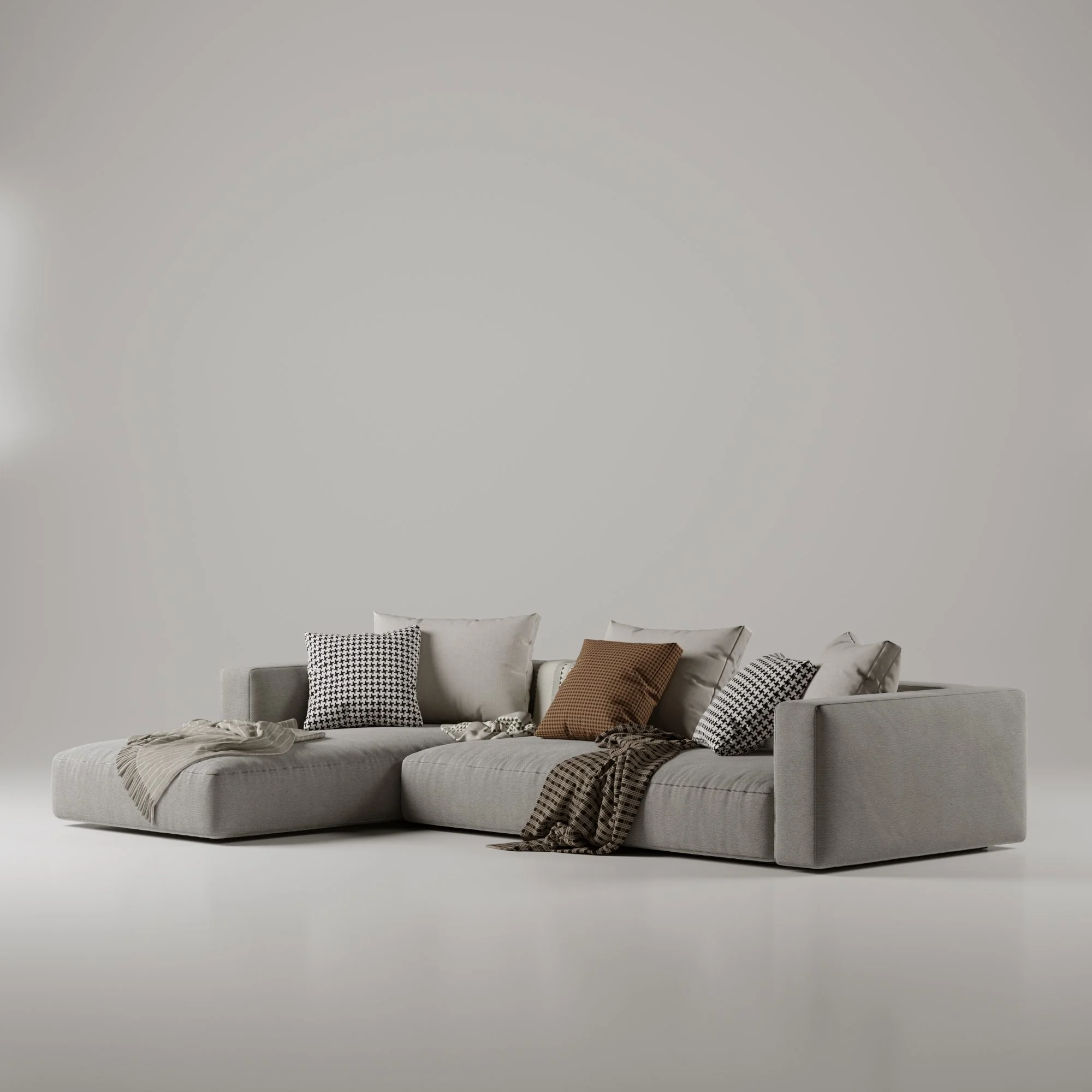 Sofá cinza decorado com almofadas e mantas em um ambiente minimalista