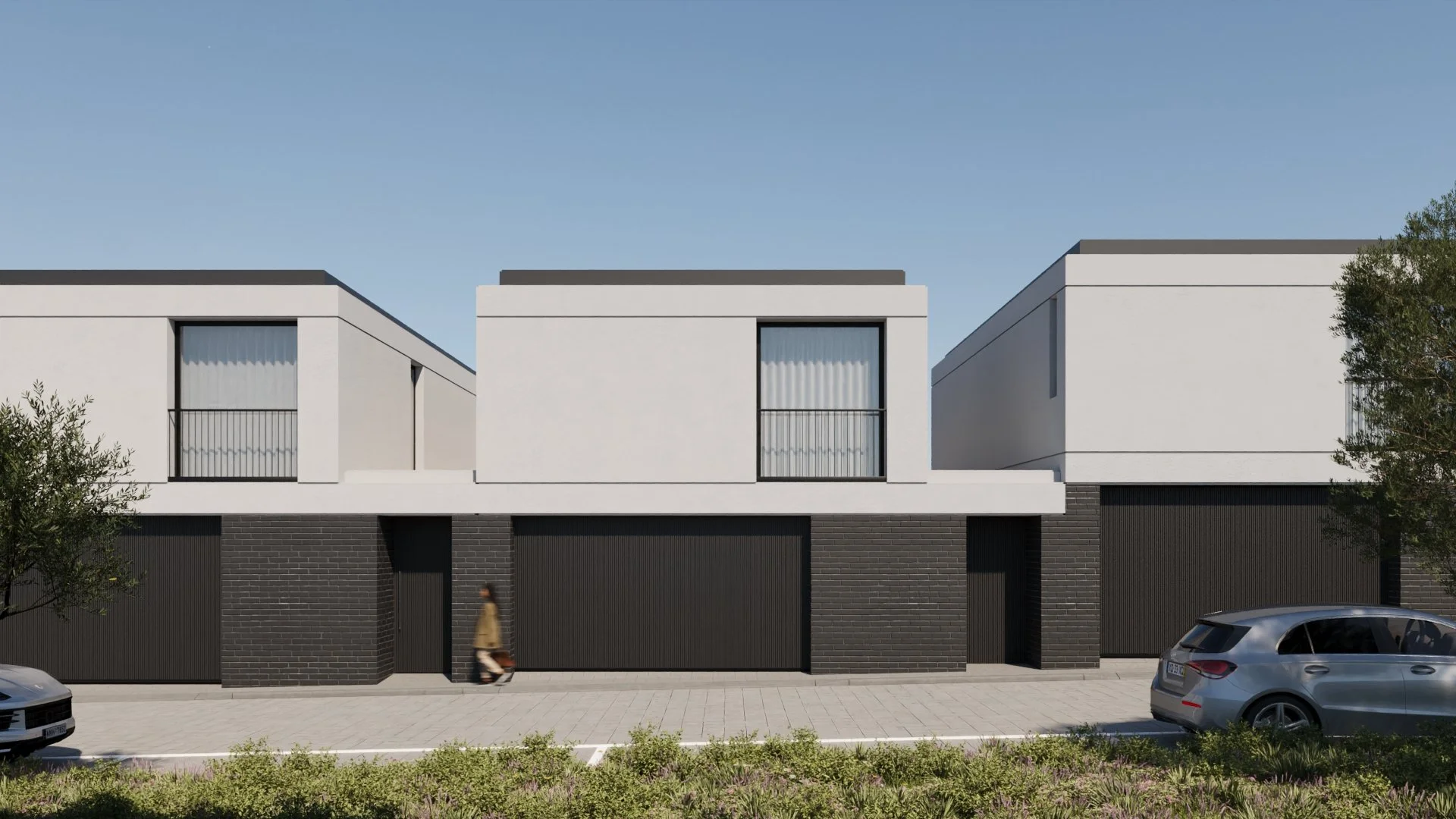 Frente de duas casas modernas com fachada branca e detalhes pretos, com duas janelas de sacada, carros estacionados na rua e pessoa caminhando na calçada, céu azul ao fundo.