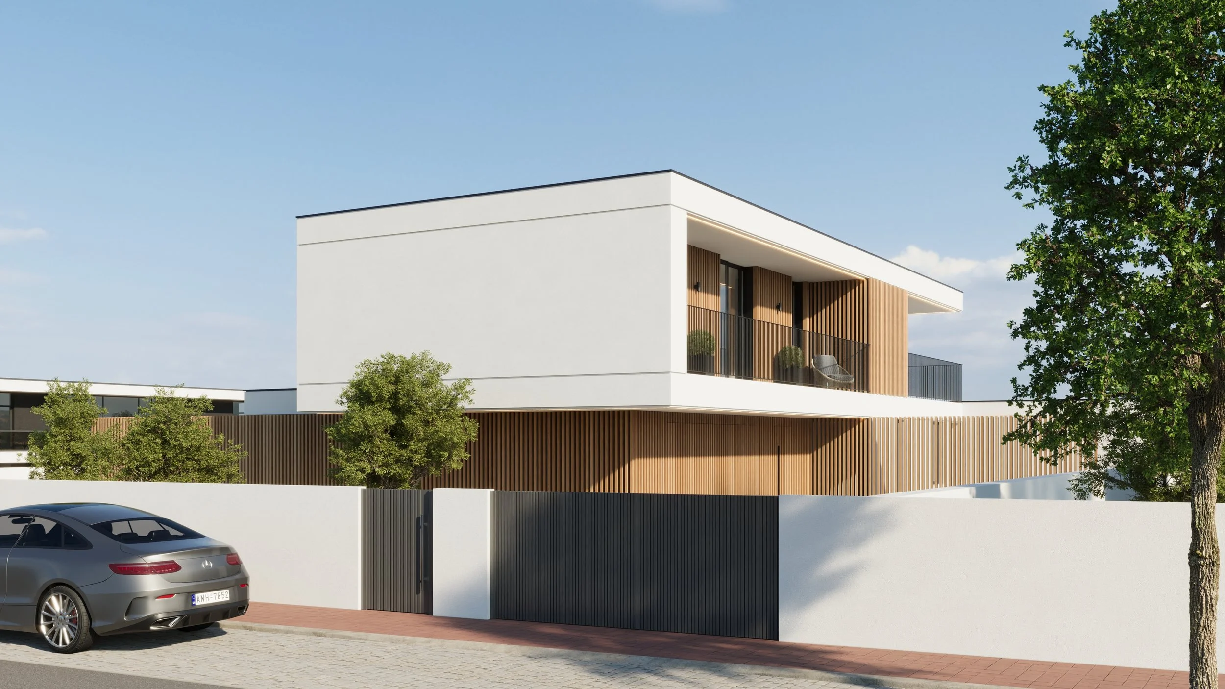 Residência moderna de dois andares com fachada branca, detalhes de madeira, varanda com vidro e plantas decorativas, cercada por muro branco e porta de entrada preta, com carro cinza estacionado na rua de calçamento.