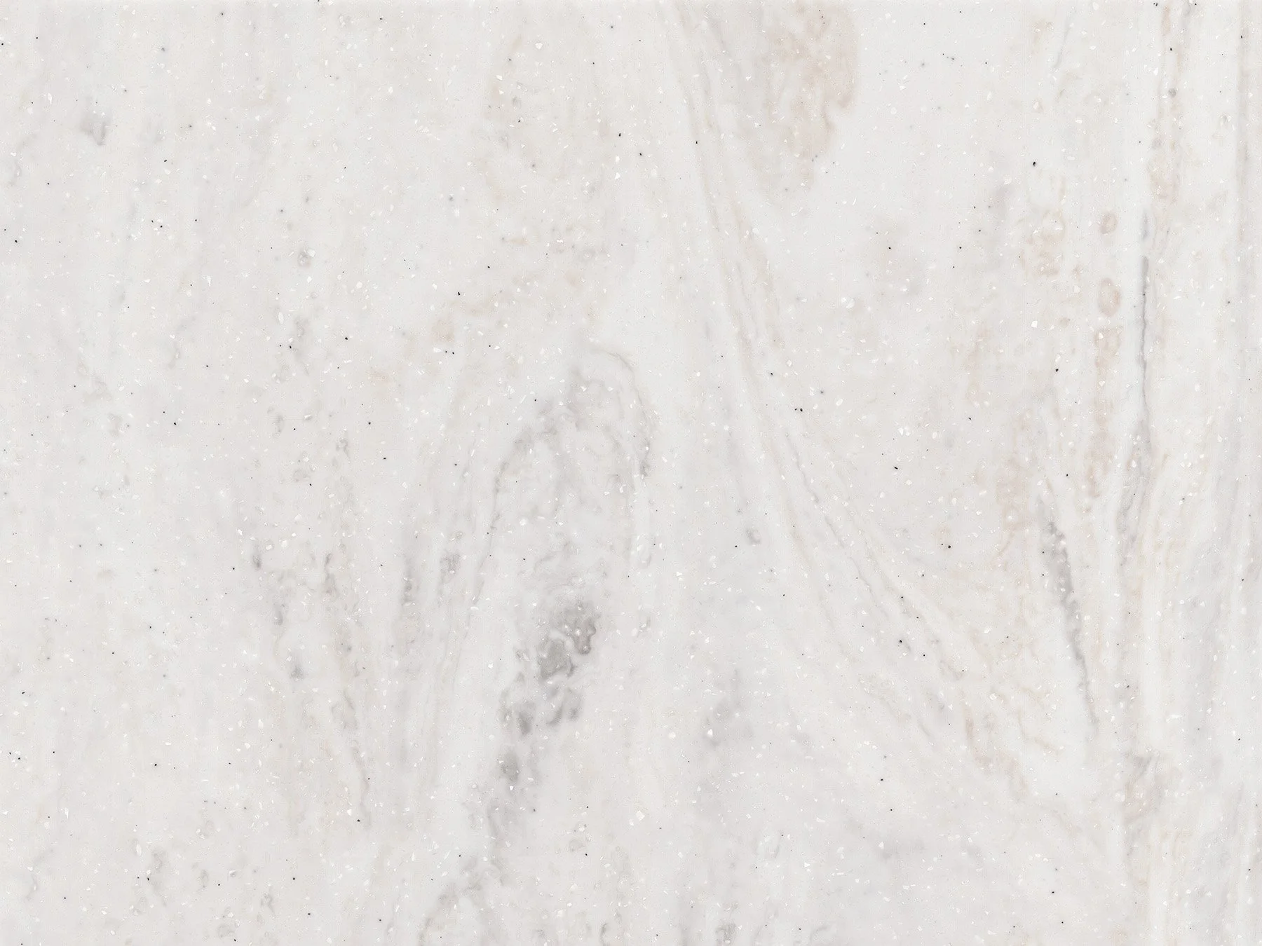 Close-up view of a white marble surface with subtle gray veining and tiny dark speckles.