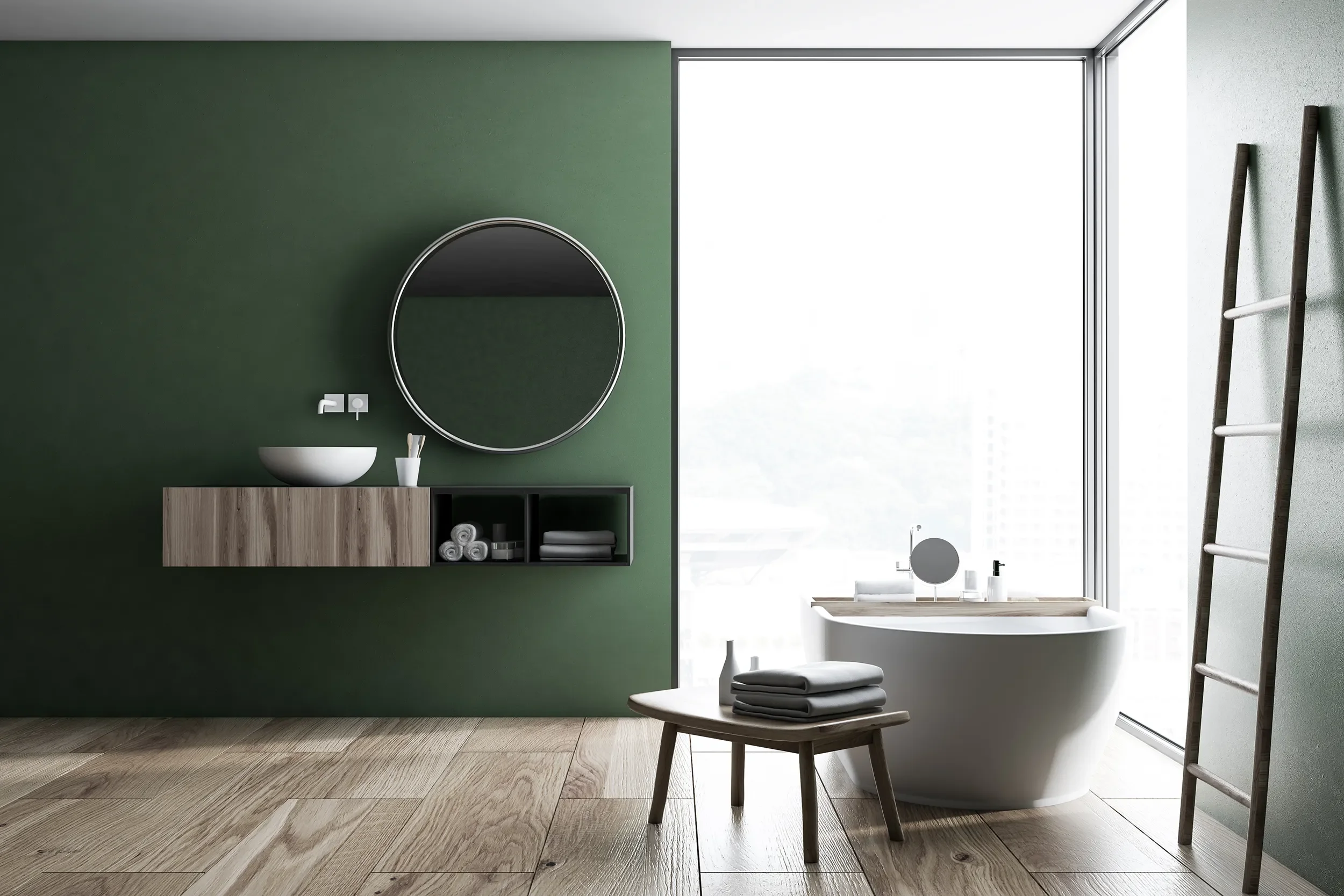 Modern bathroom with green accent wall, round mirror, vessel sink, wooden cabinet, towels, wooden stool, and large window with natural light.