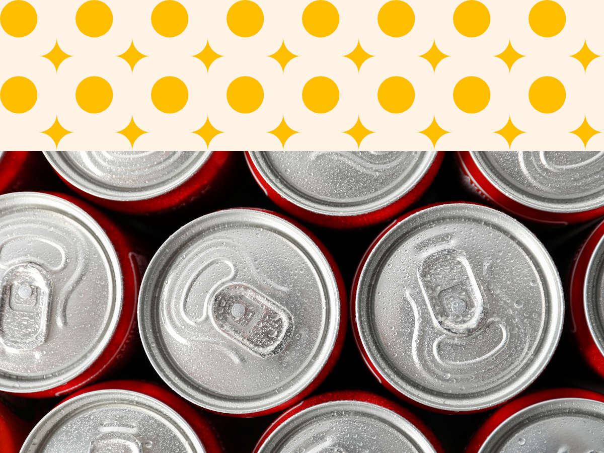 Top view of several cans of soda with condensation on the lids.