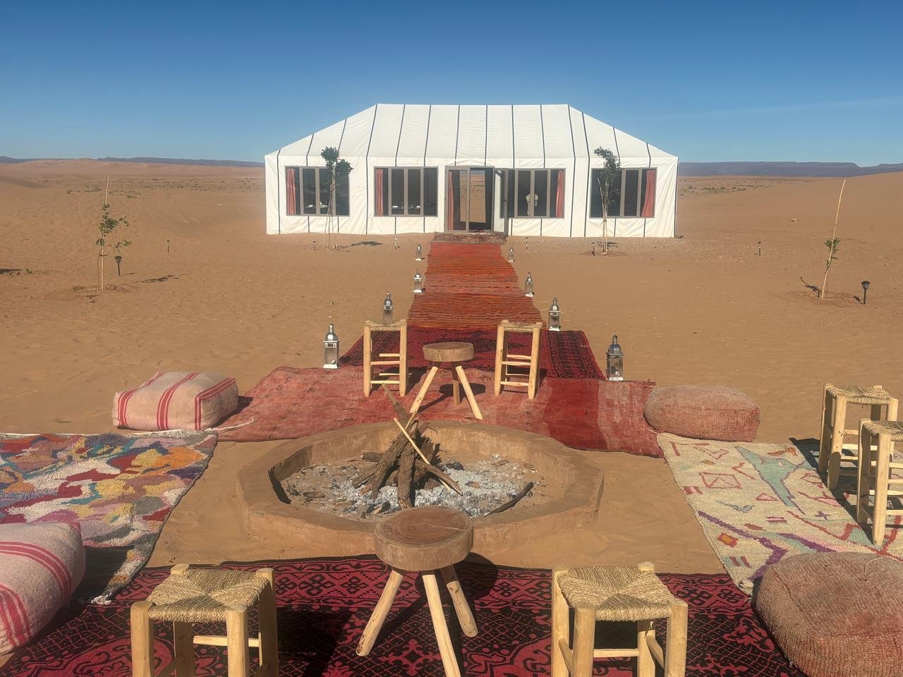 View of the restaurant at Arawan Luxury Desert Camp from the fire pit in the morning.