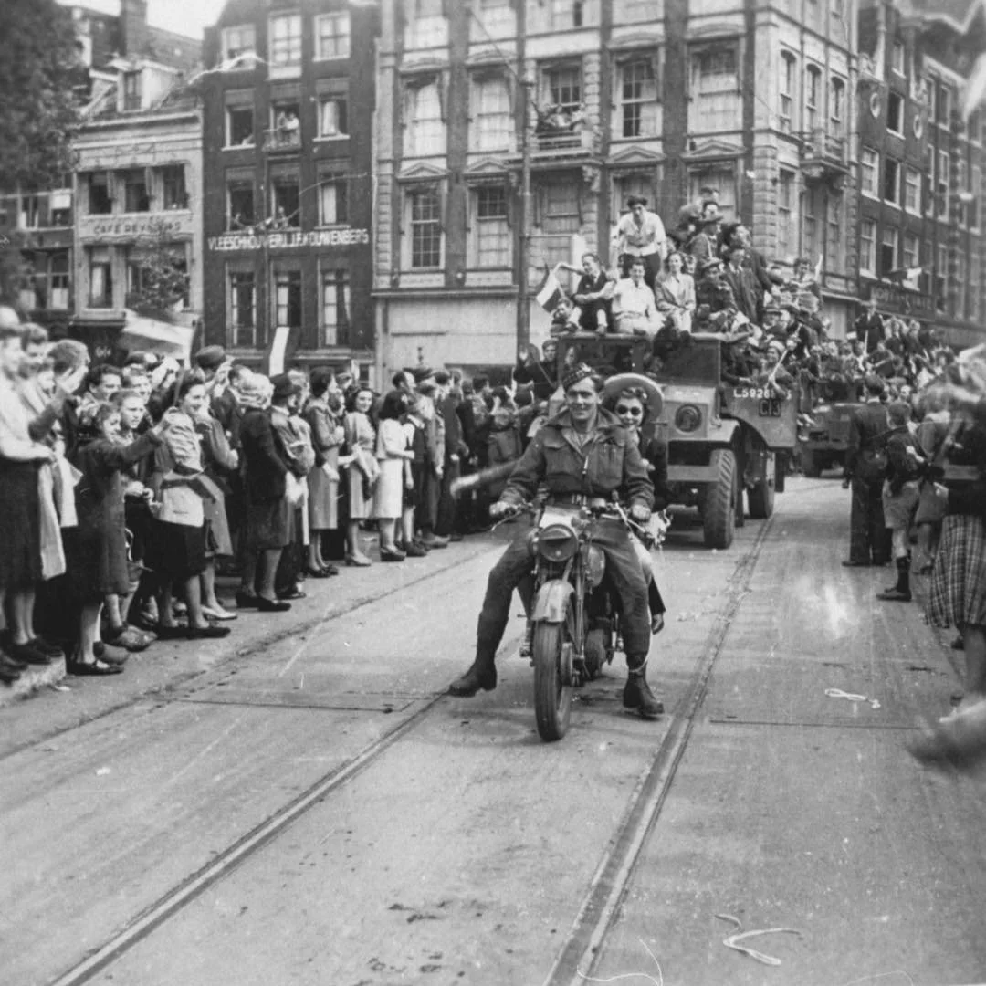 1945 &amp; Now: in this photo you see Canadian soldiers driving through the city, with the liberated Amsterdam citizens celebrating in the streets. This photo was taken at Leidseplein, looking at the entrance of Leidsestraat. #thenandnowamsterdam