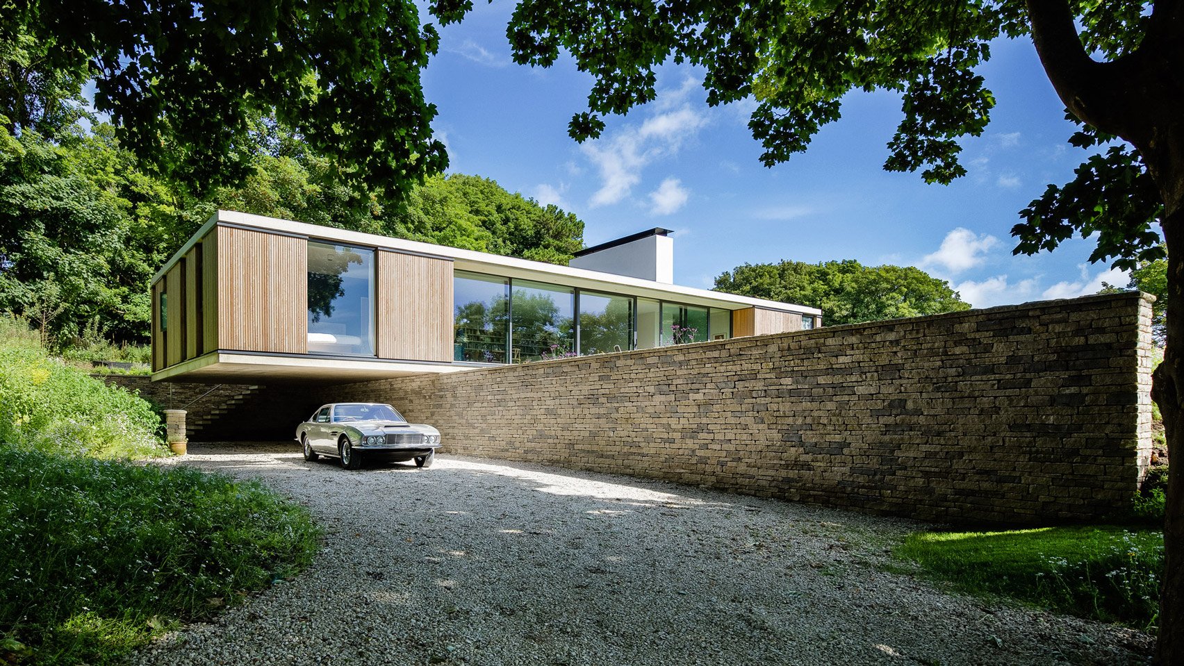 1970s Aston Martin outside a house.