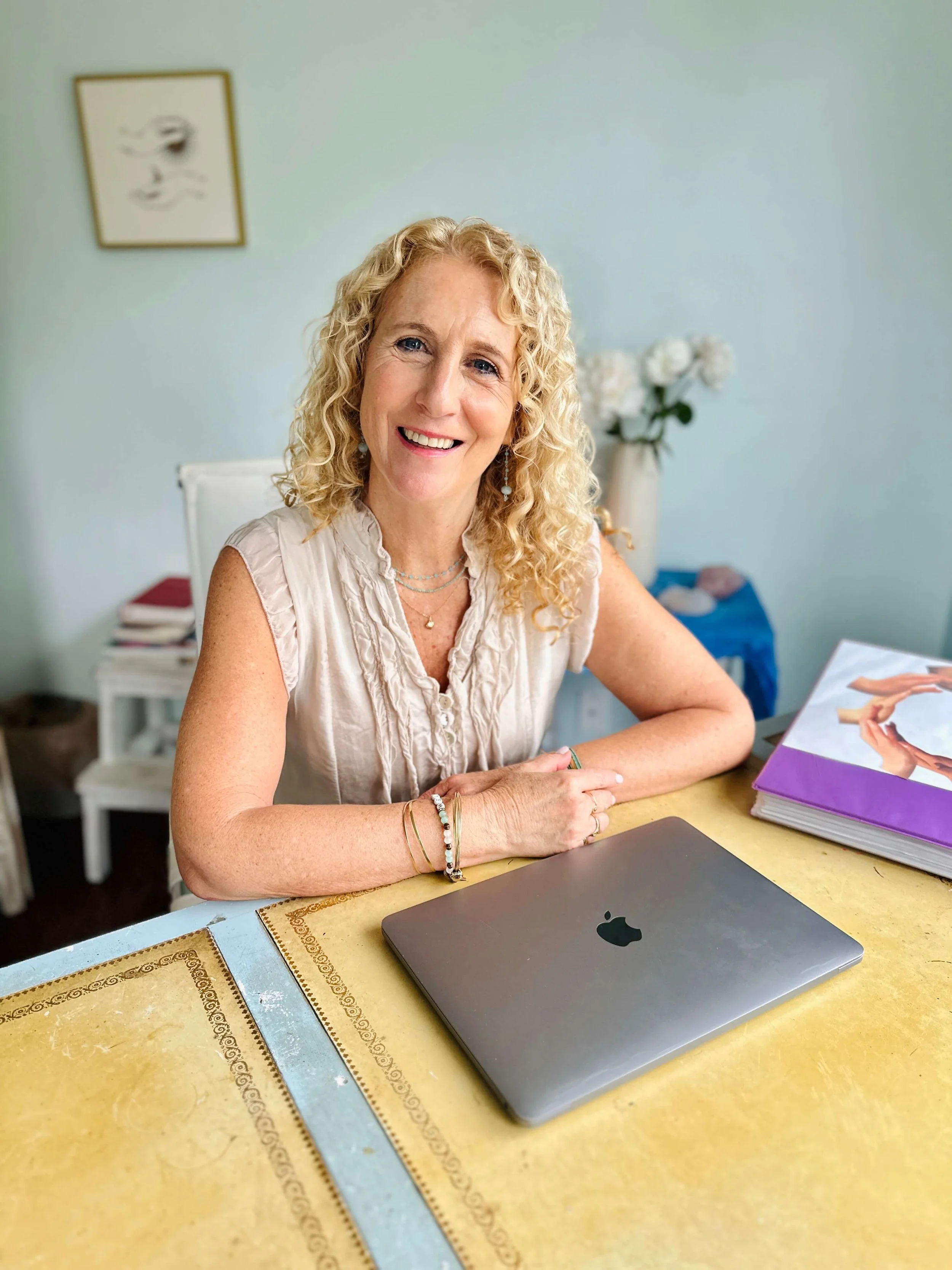 Jozi Radus at her home office, smiling to her client