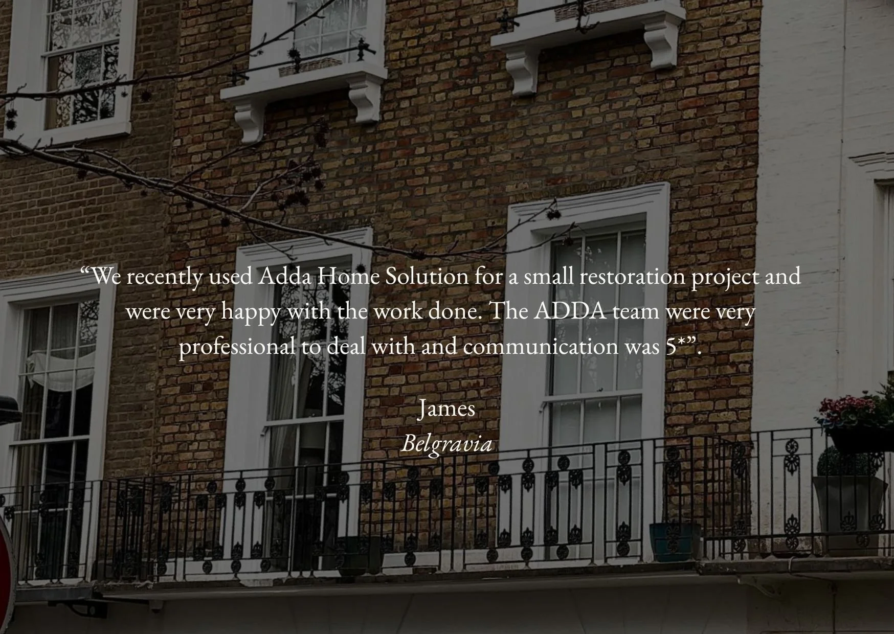 Quote testimonial overlay on a brick building exterior with windows and a balcony with potted plants, mentioning the use of Adda Home Solution for a restoration project.