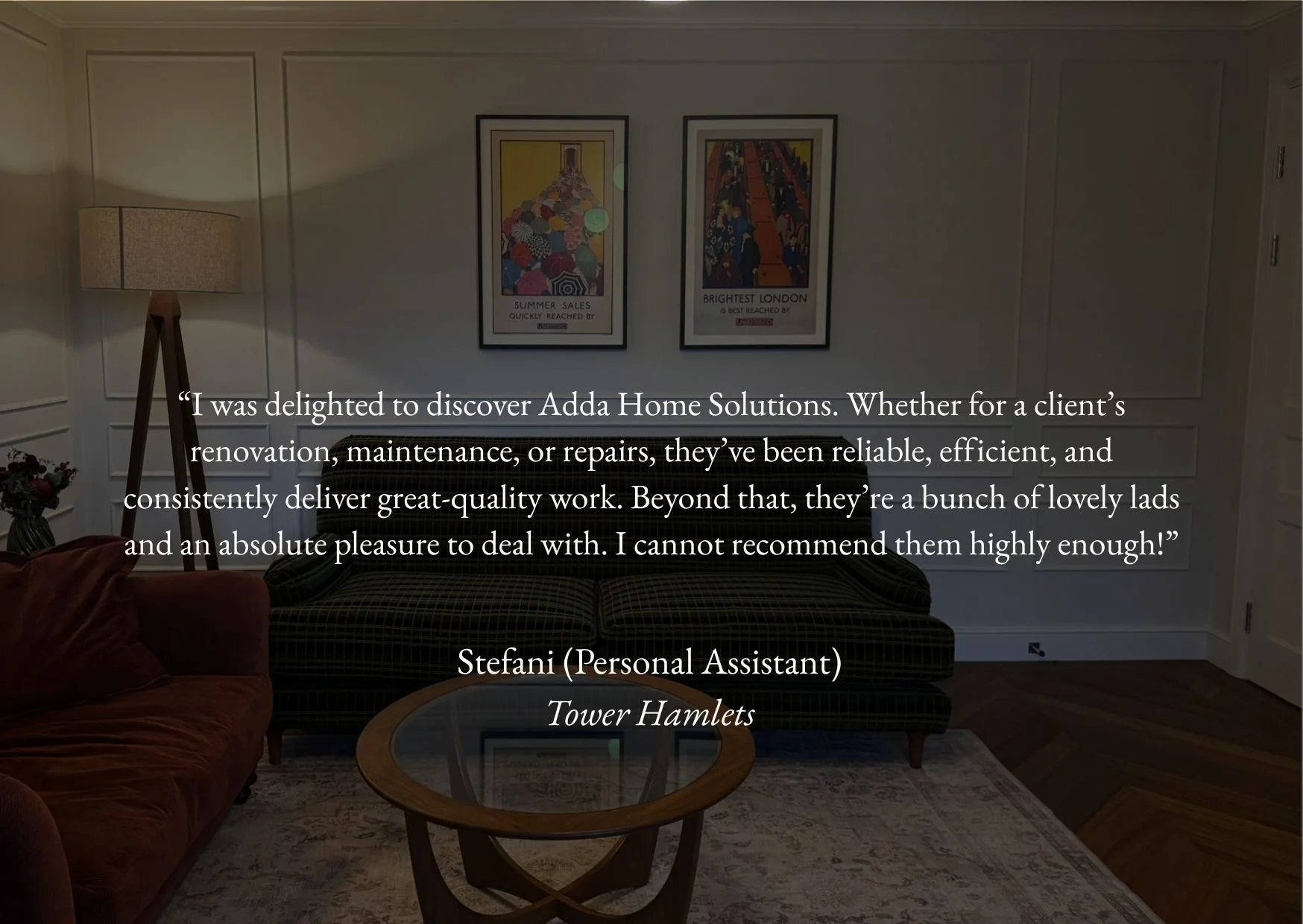 Living room with two framed posters on the wall, a beige floor lamp, a brown velvet armchair, a patterned sofa, a glass-top coffee table, a flower vase, and an area rug.