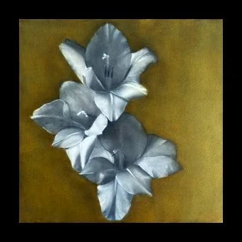 Silver-colored metallic leaves on a brown background.