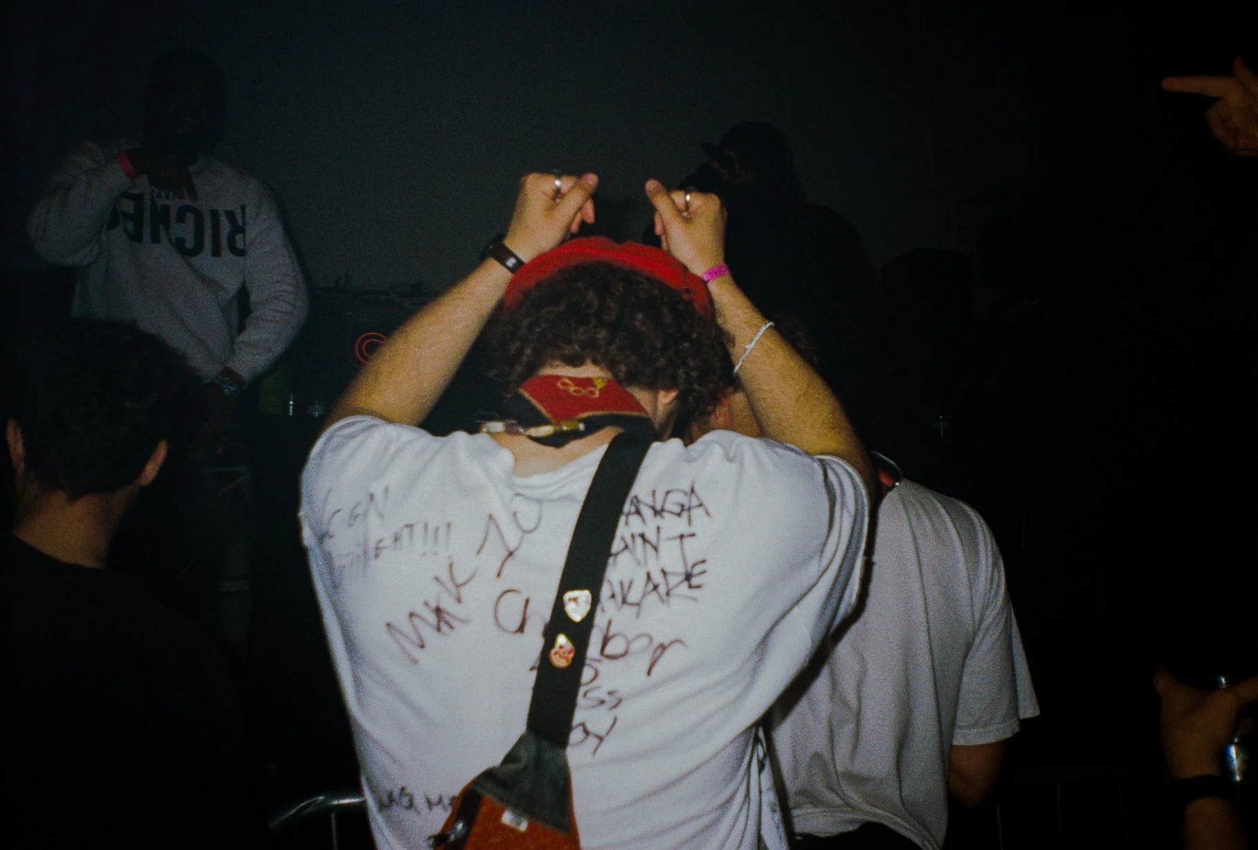 the back of a young man dancing in a rave