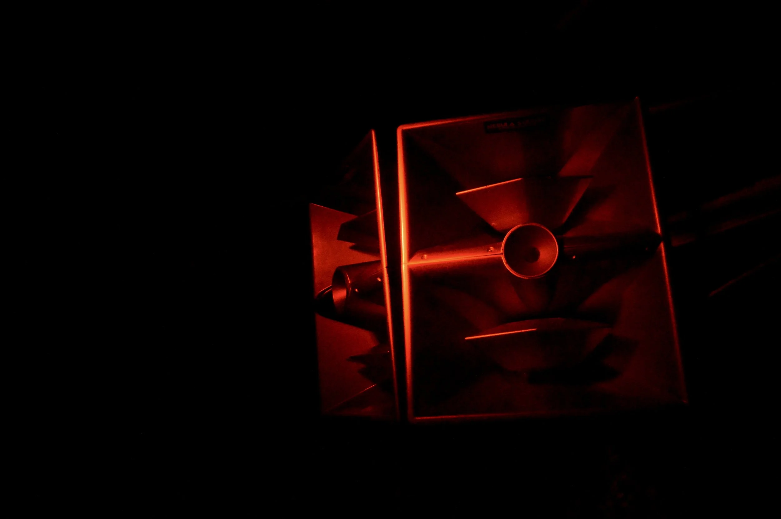shadowed event speaker with red lighting