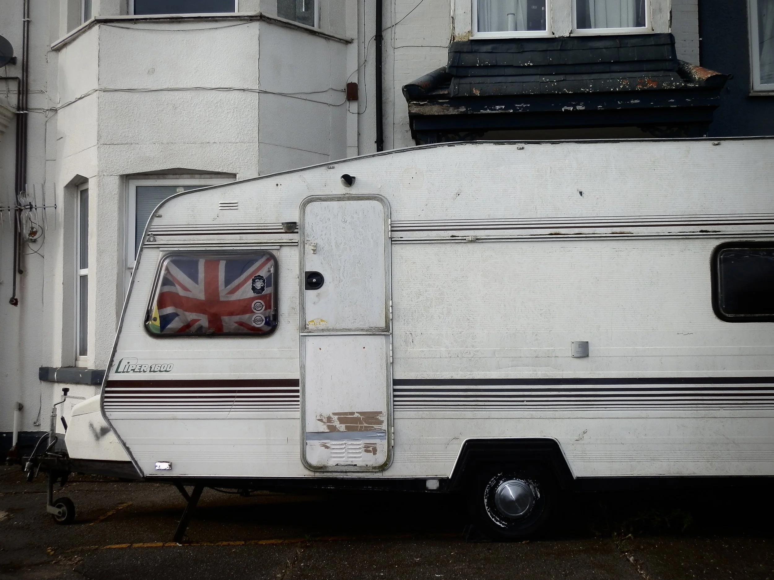 White camper van with Union Jack in the window 