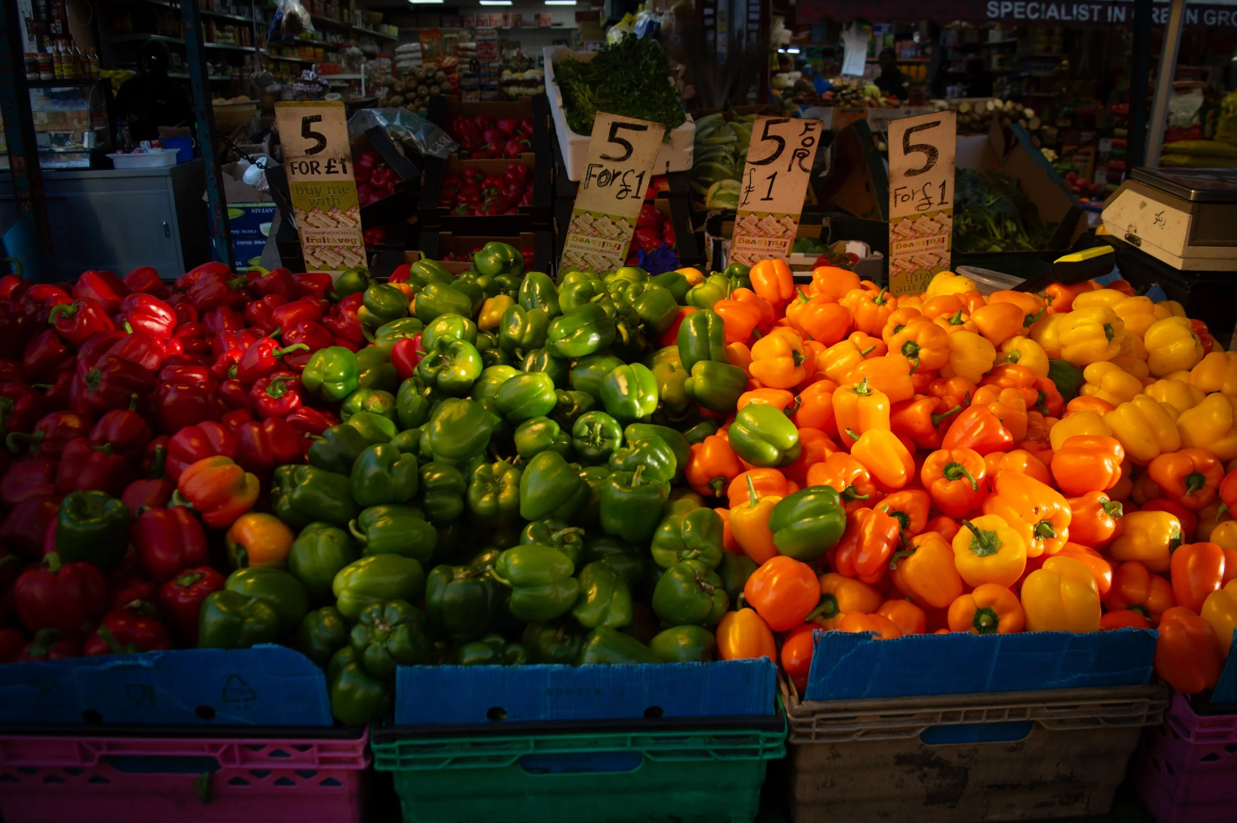 red green and yellow peppers on a fruit and veg stall at East Street Market