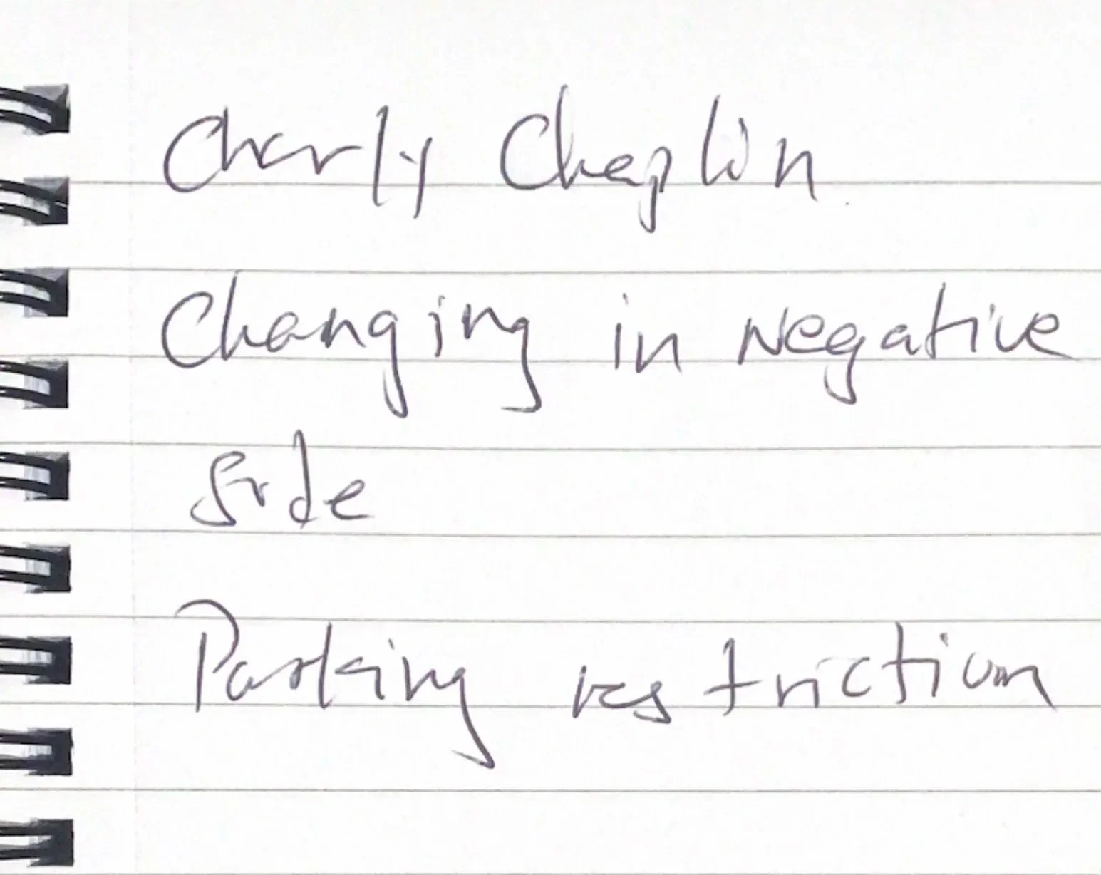 a scan of a notebook I took around Southwark, I asked residents to write three words that first come to mind when they think about the area and this one reads 'charley Chaplin, changing in negative side, partially restriction'