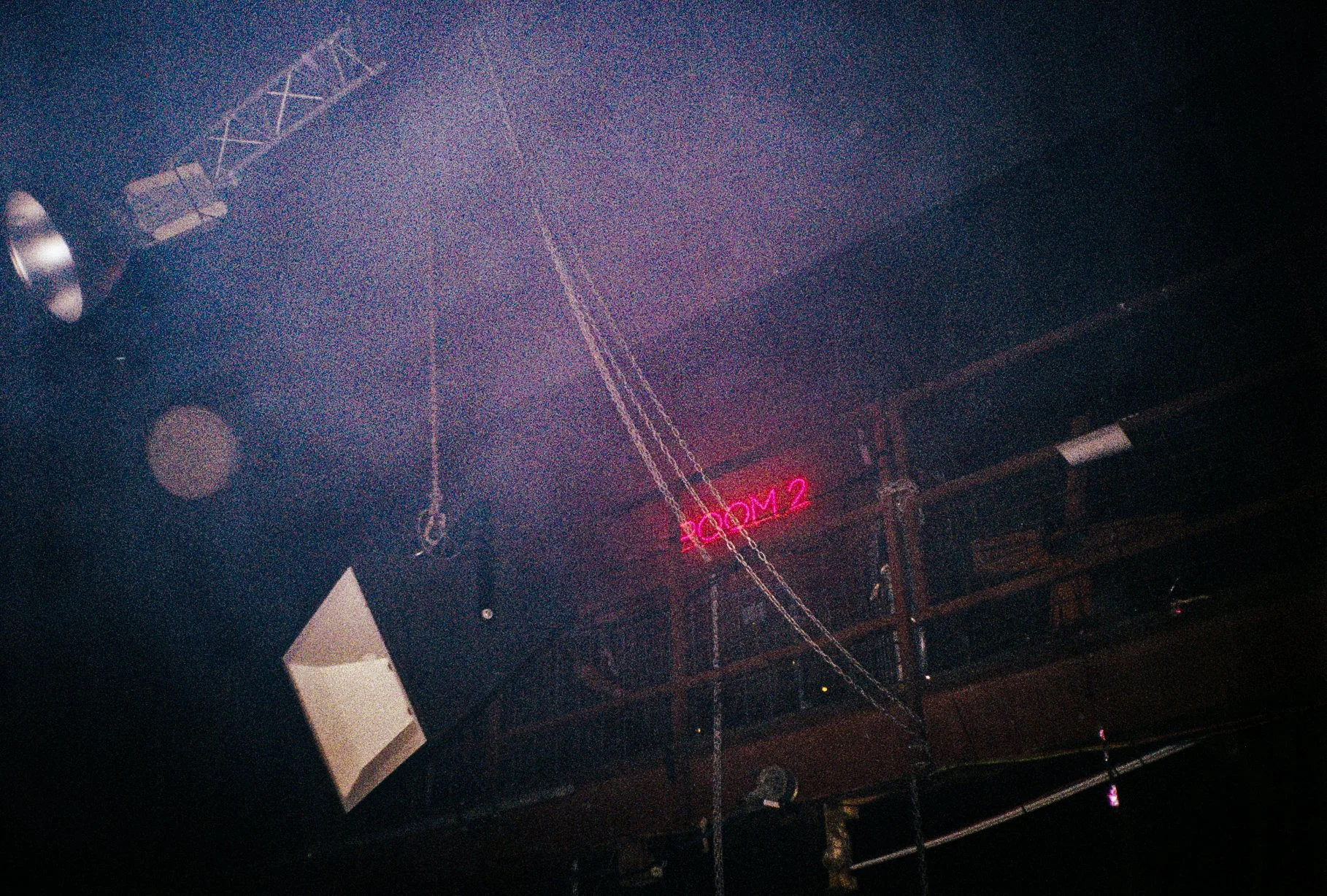 foggy photo of red LED room 3 sign