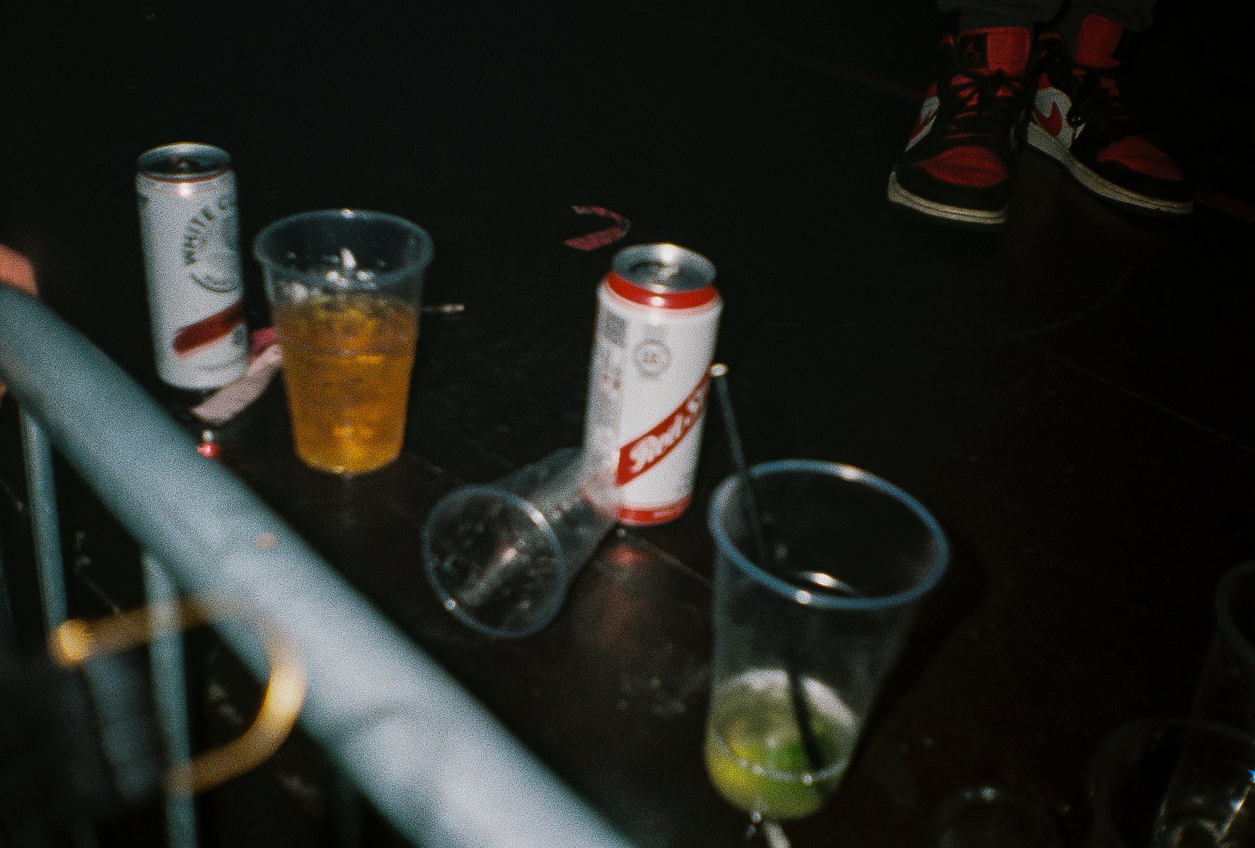 beer cans and plastic drinks cups on the side of the stage 