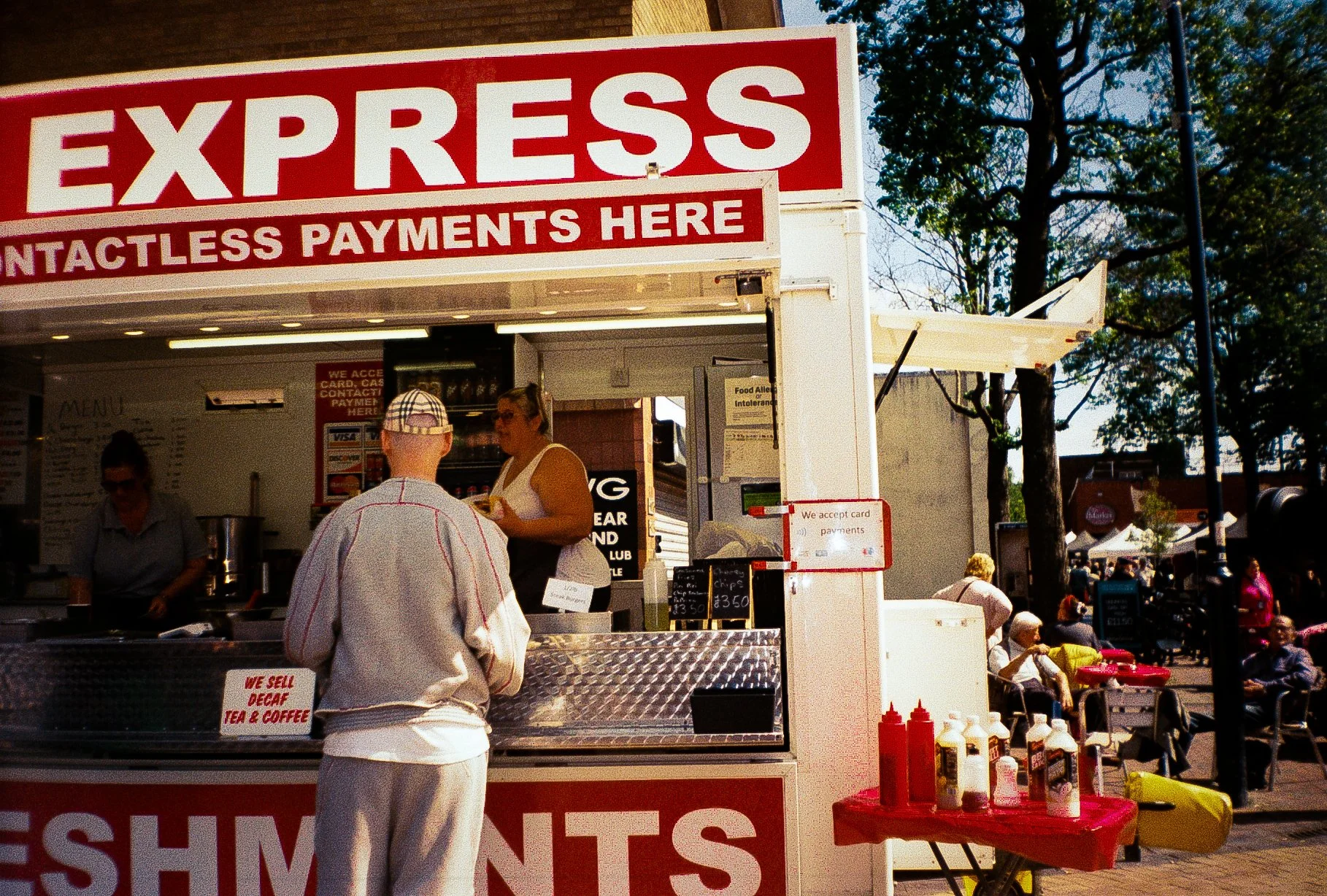 young man ordering food at a burger van for streetwear campaign 