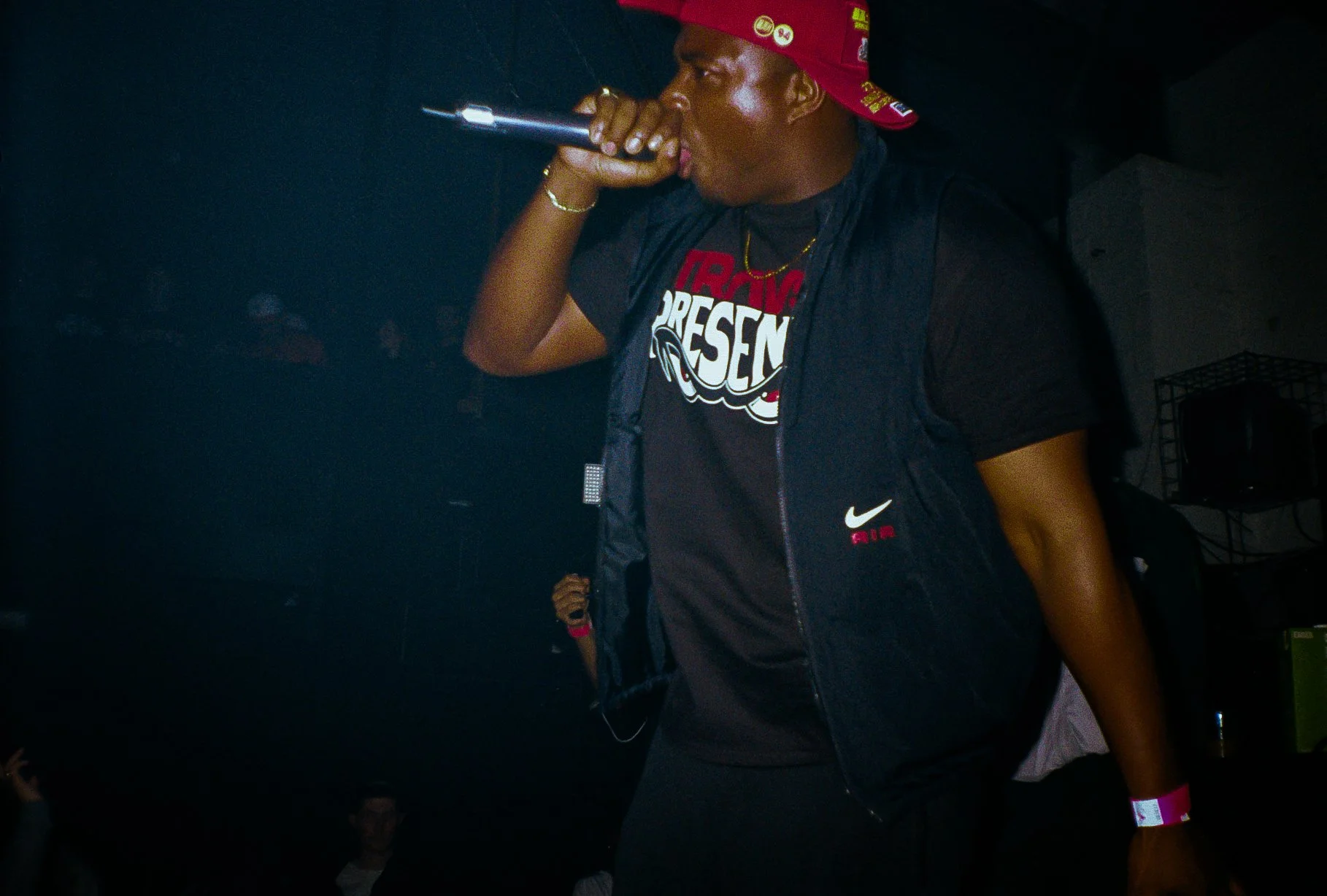 grime musician Kruz Leone performing into mic at a travspresents rave 