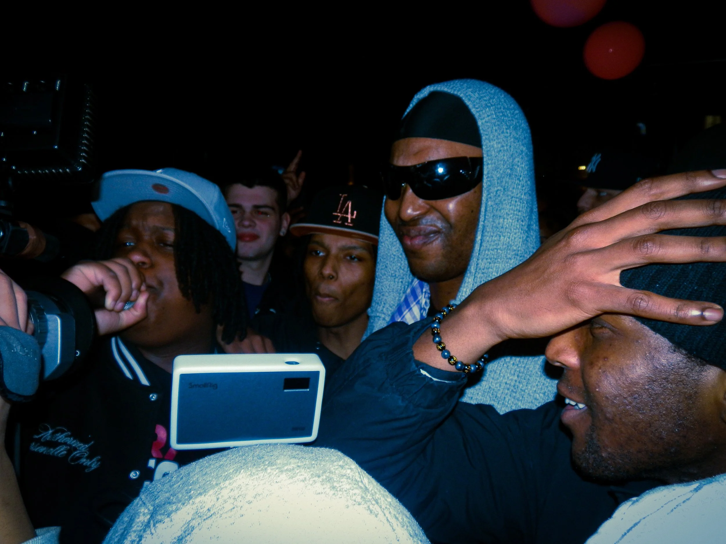 N3 performing at travspresents grime rave in the middle of a crowd with camcorders in his face