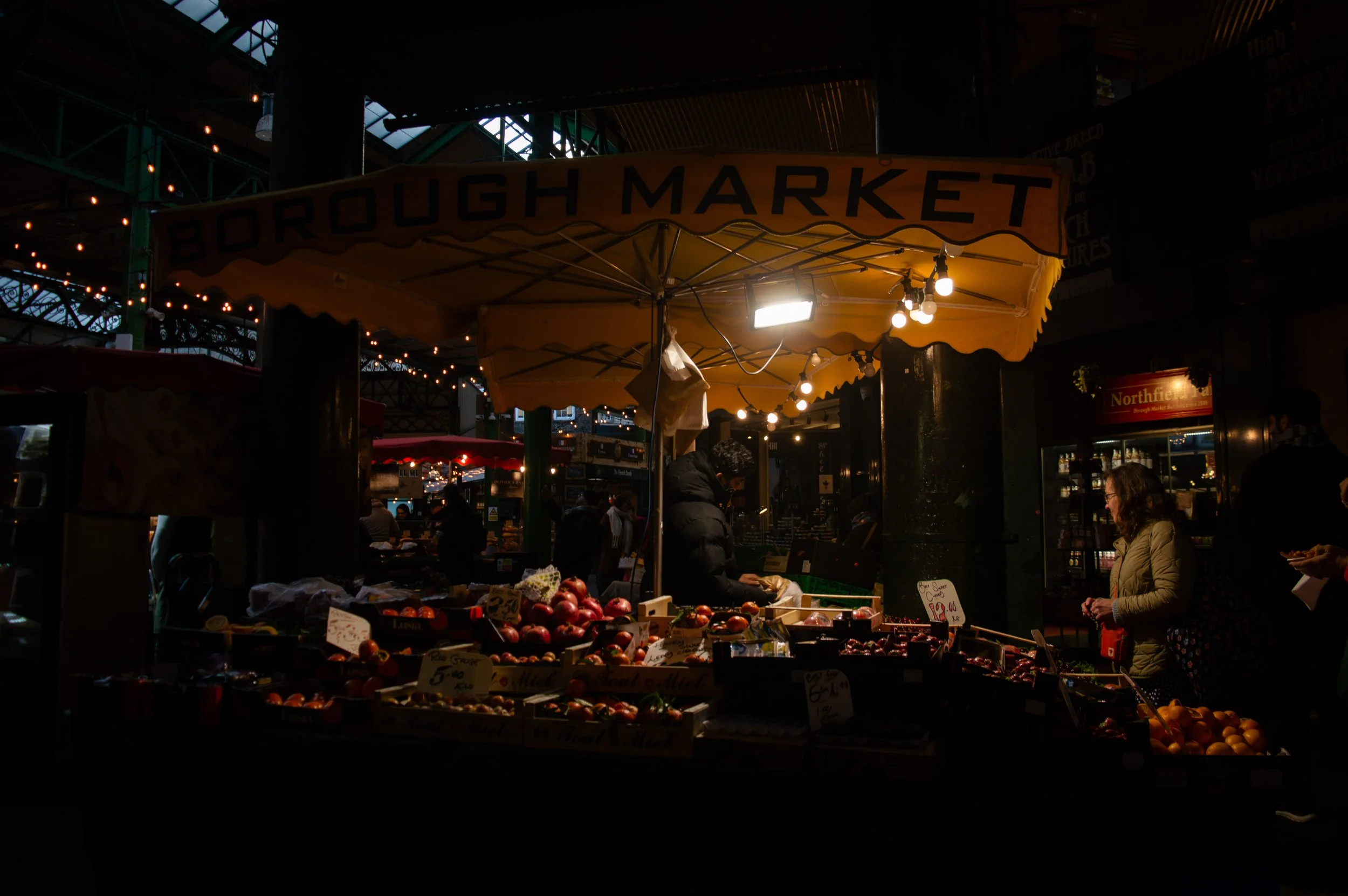 Borough Market produce stall in low light dimly lit 