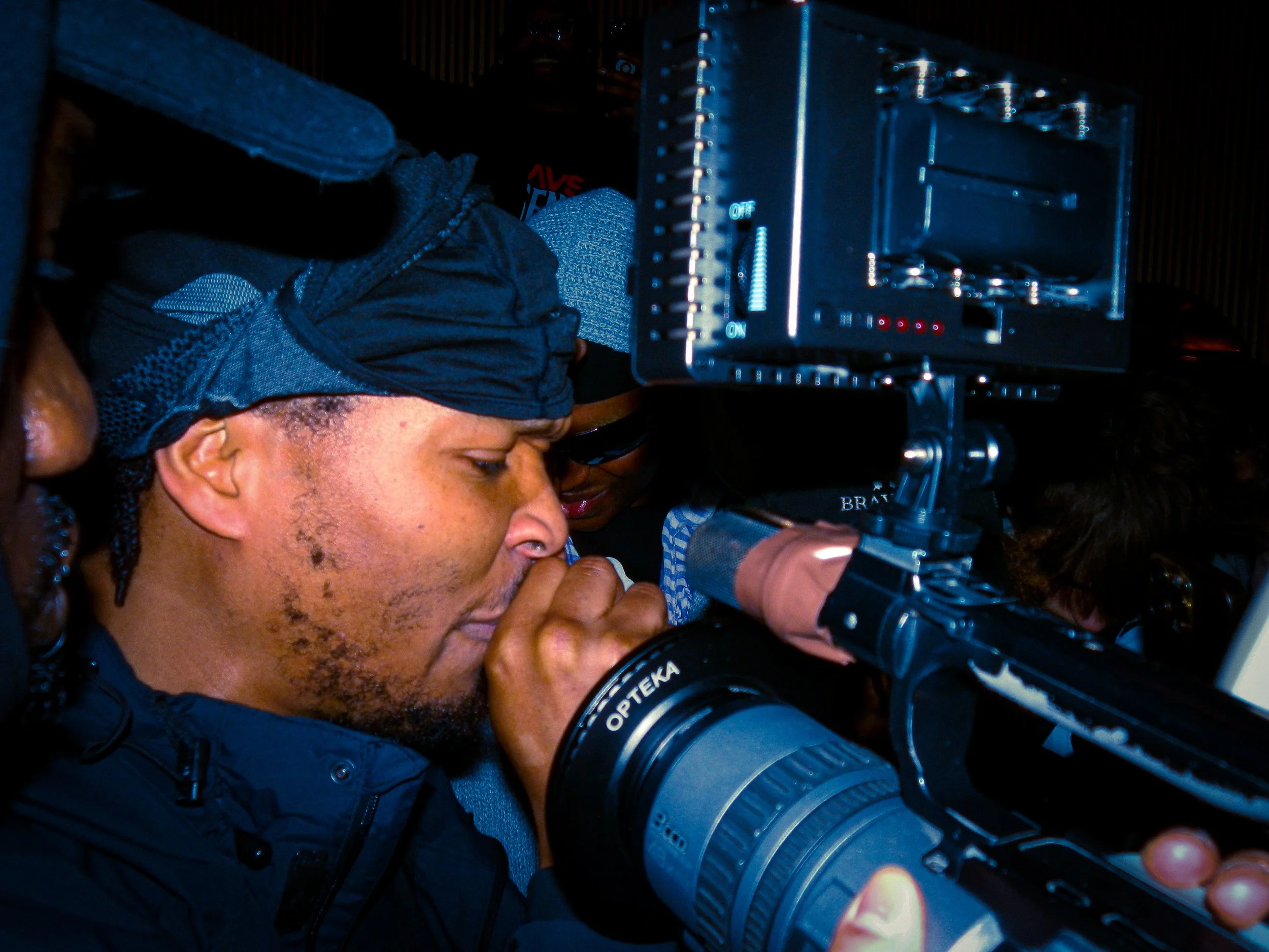 mercy ace performing at travspresents grime rave in the middle of a crowd with camcorders in his face
