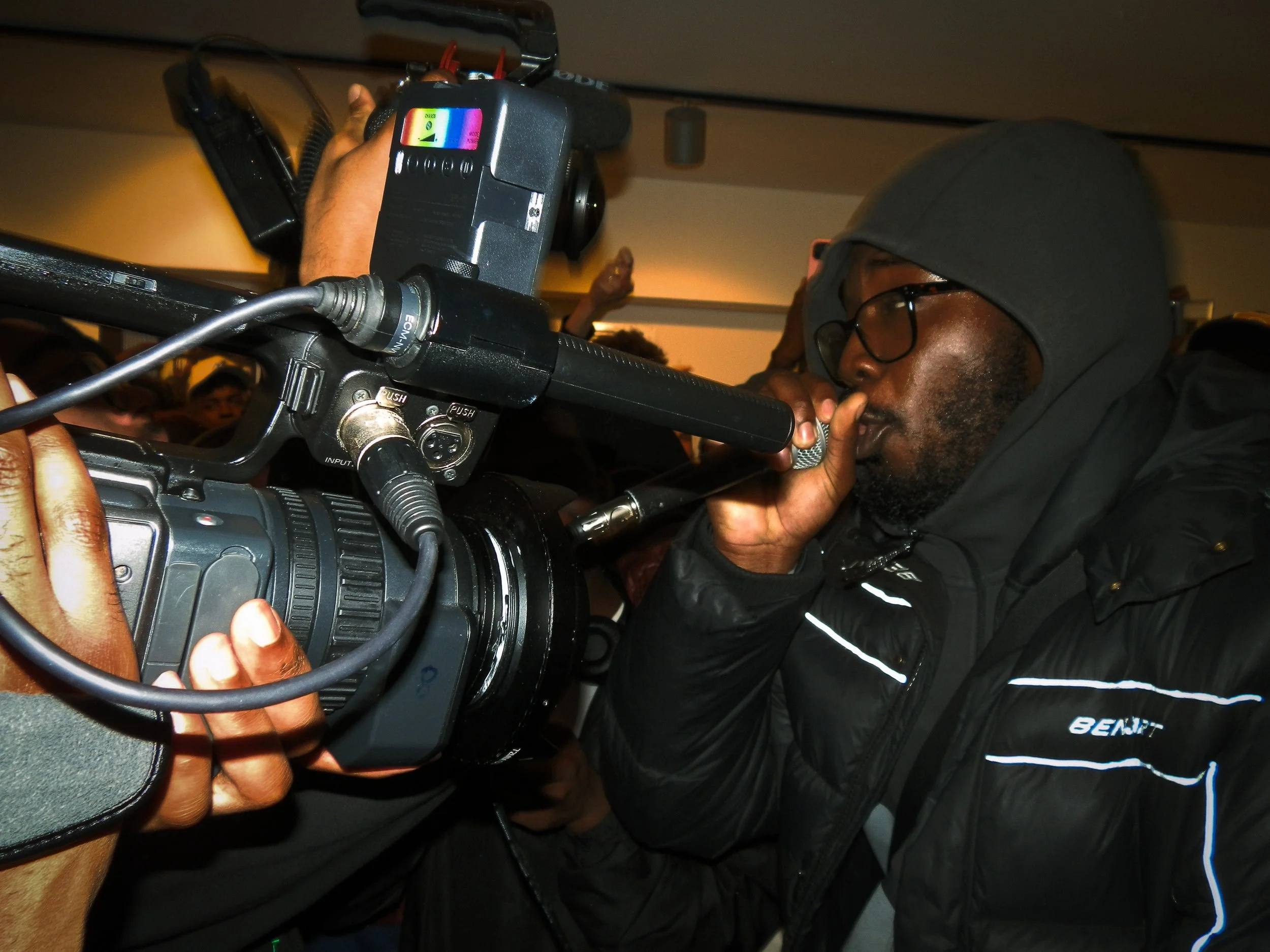 Grime mc performing into mic and cs, corded at the victory lap cypher for the Simon Wheatley don’t call me urban pop up shop book launch 