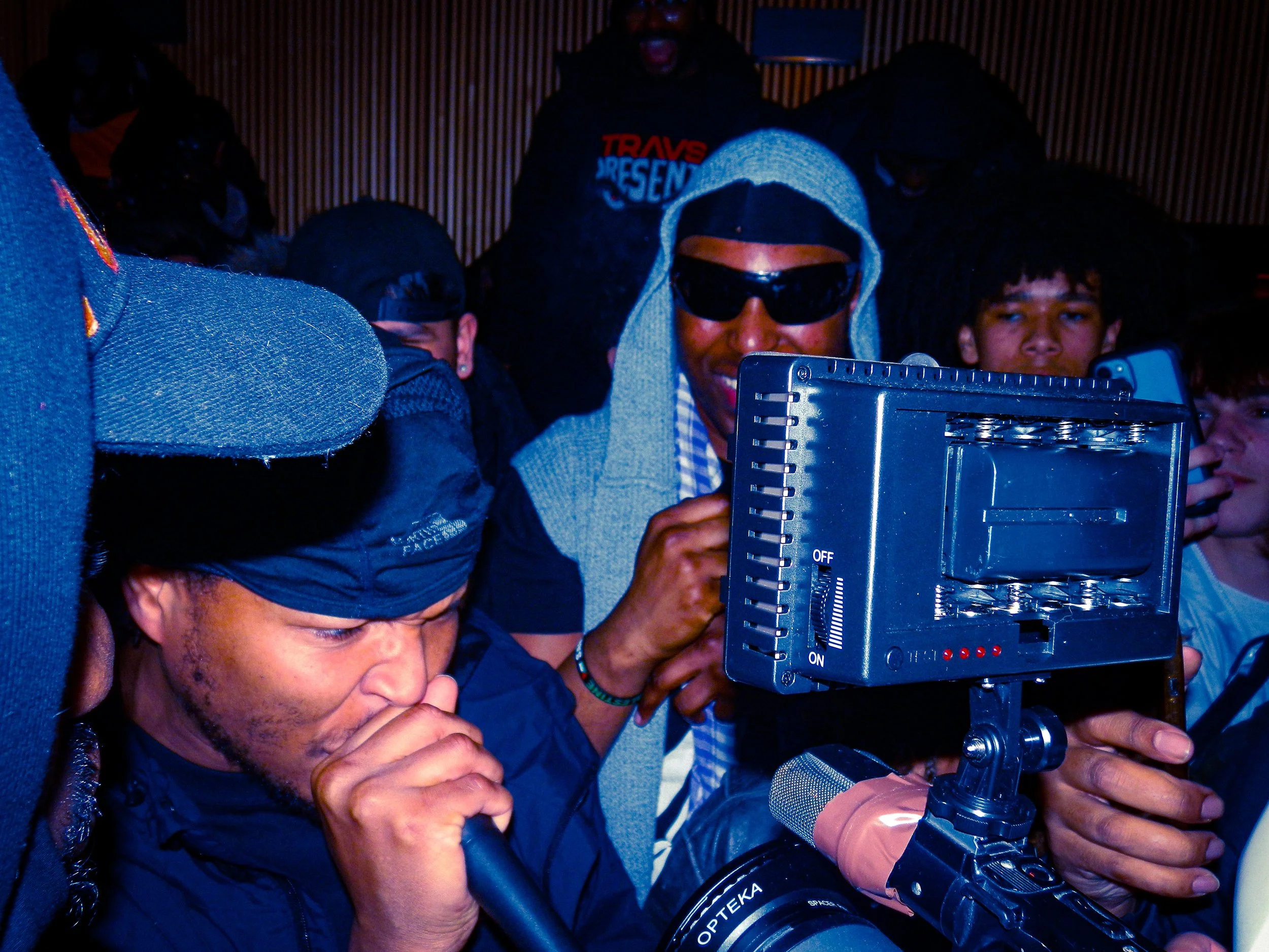 mercy ace performing at travspresents grime rave in the middle of a crowd with camcorders in his face