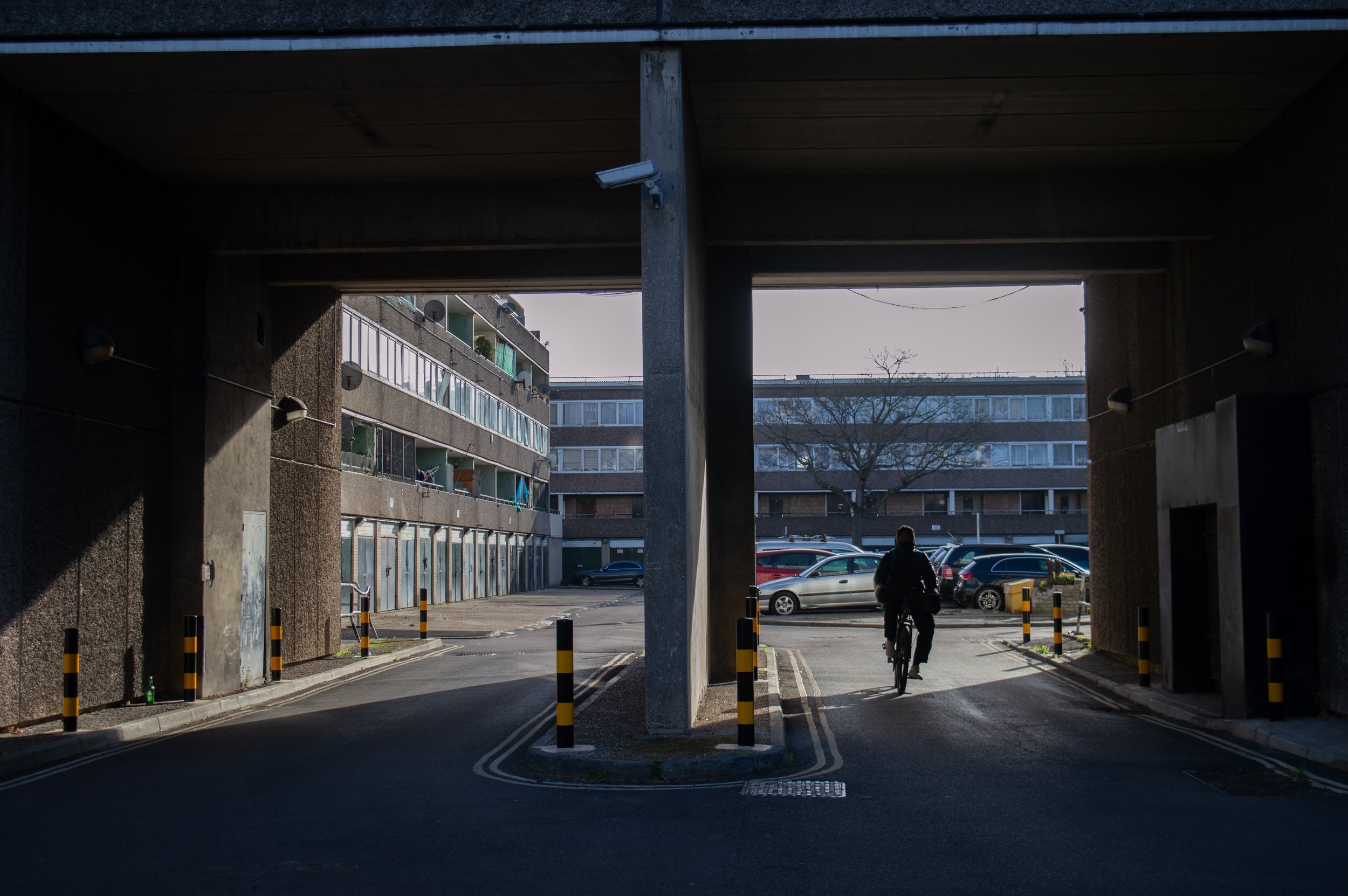 a man cycling from a car park at Aylesbury Estate