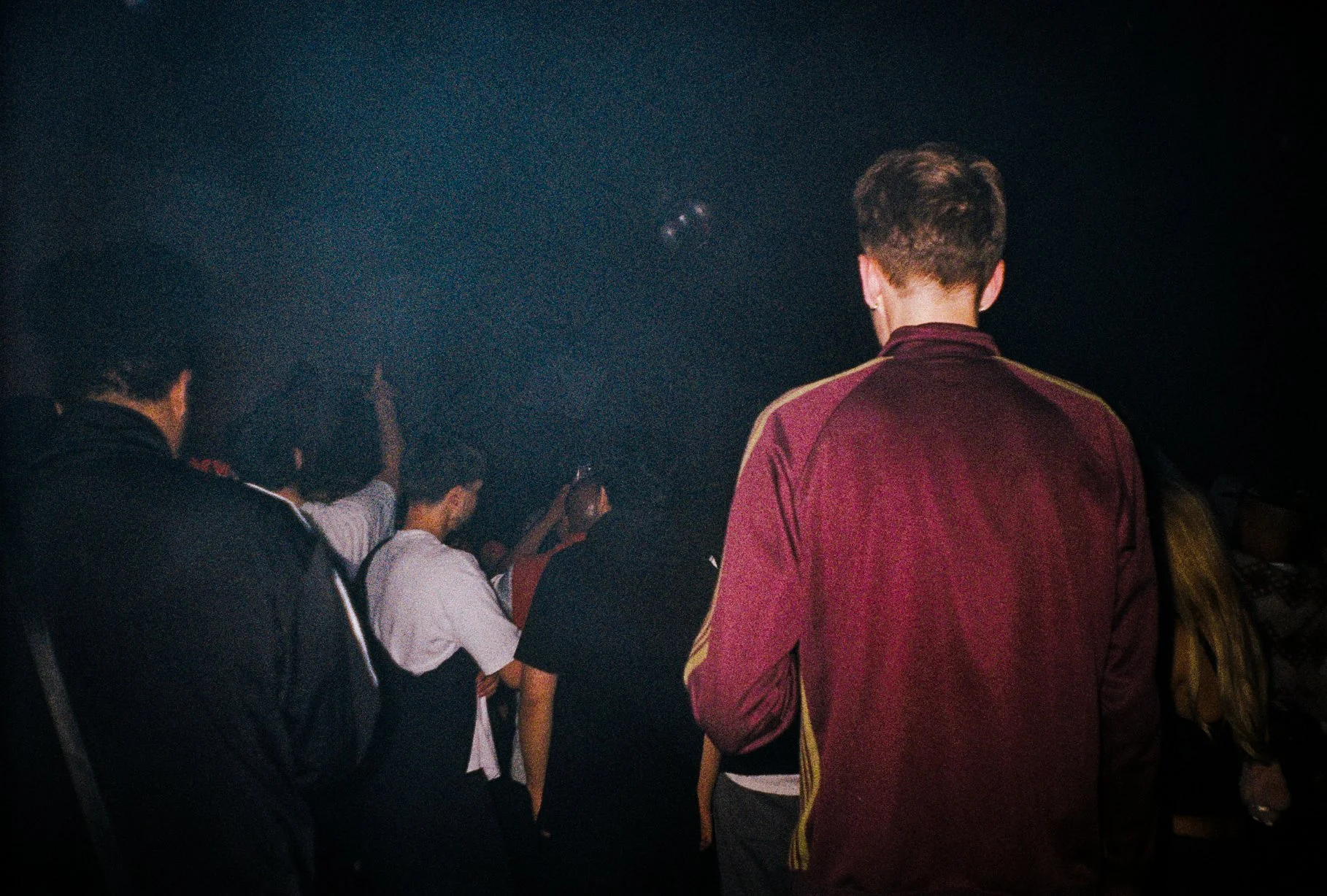 hazy image of ravers standing at a stage in London