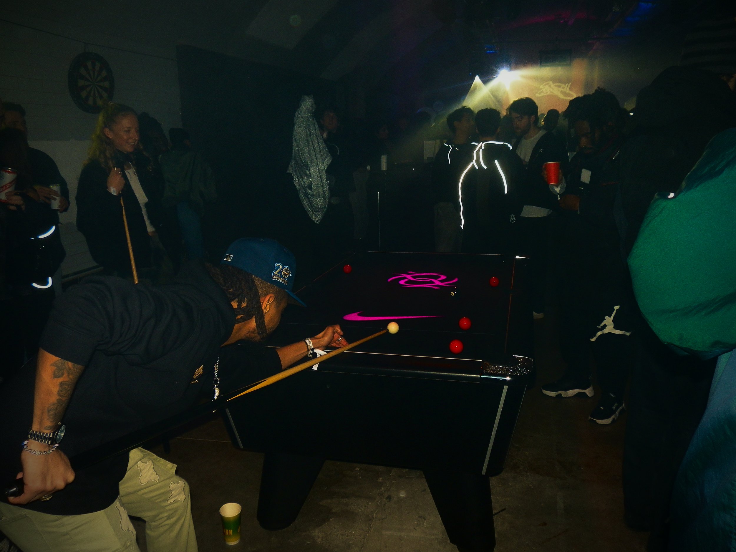 Young man playing pool at Pastdown Vintage's collaboration with Nike pop up store event