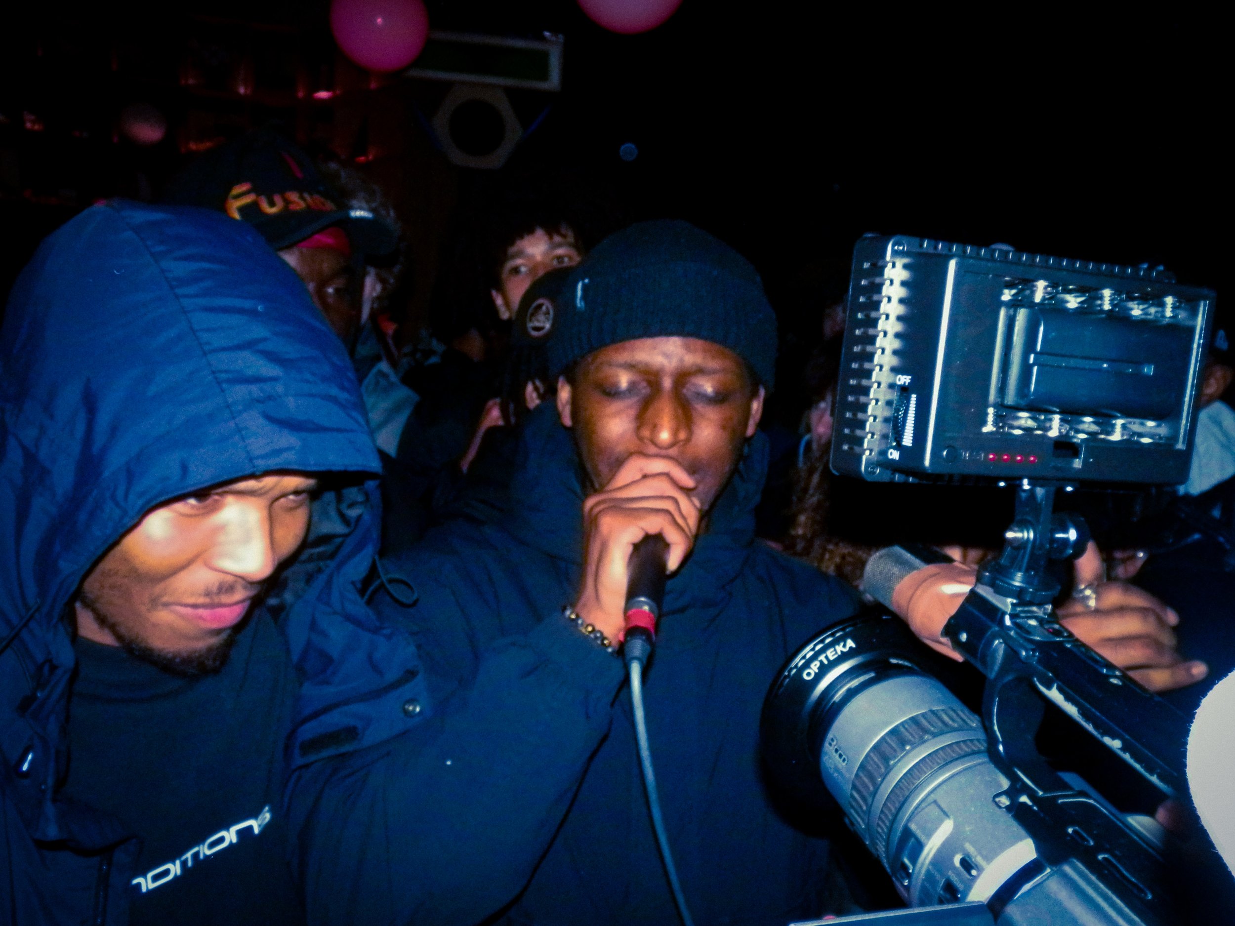 grime musician elf performing into mic and camera at travspresents grime rave London with mercy ace stood next to him