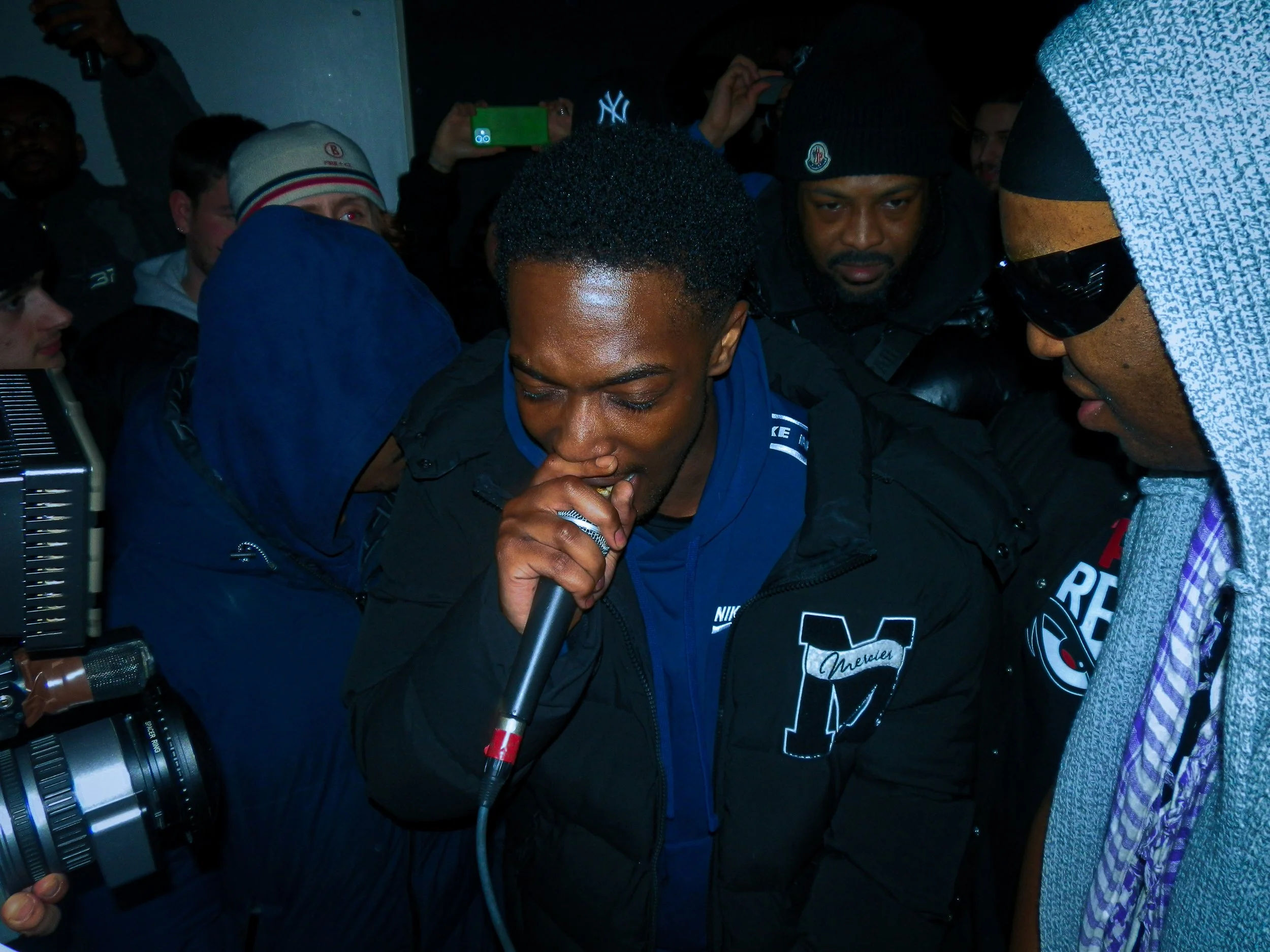 Mez performing at travspresents grime rave in the middle of a crowd 