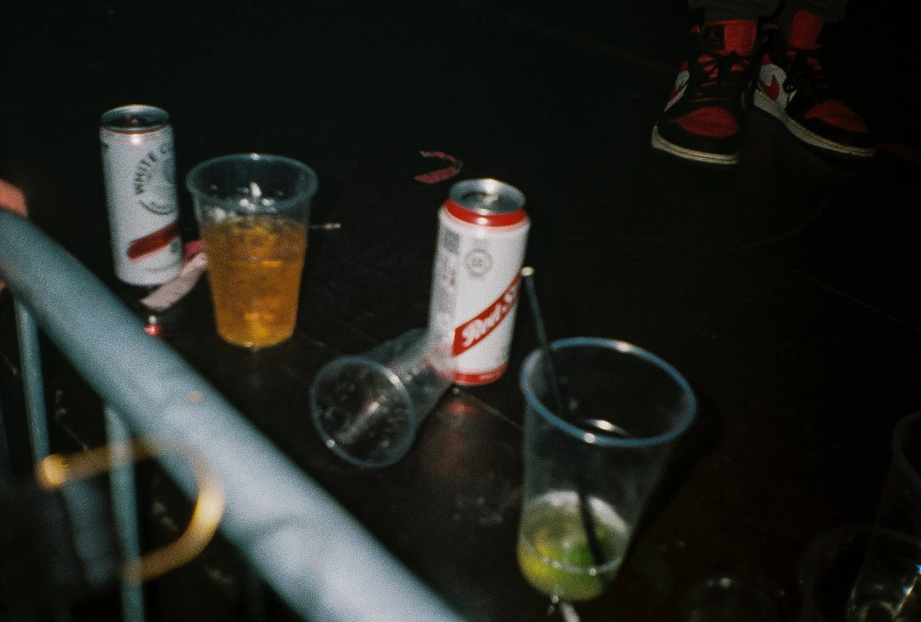 beer cans and plastic cups on the side of a stage