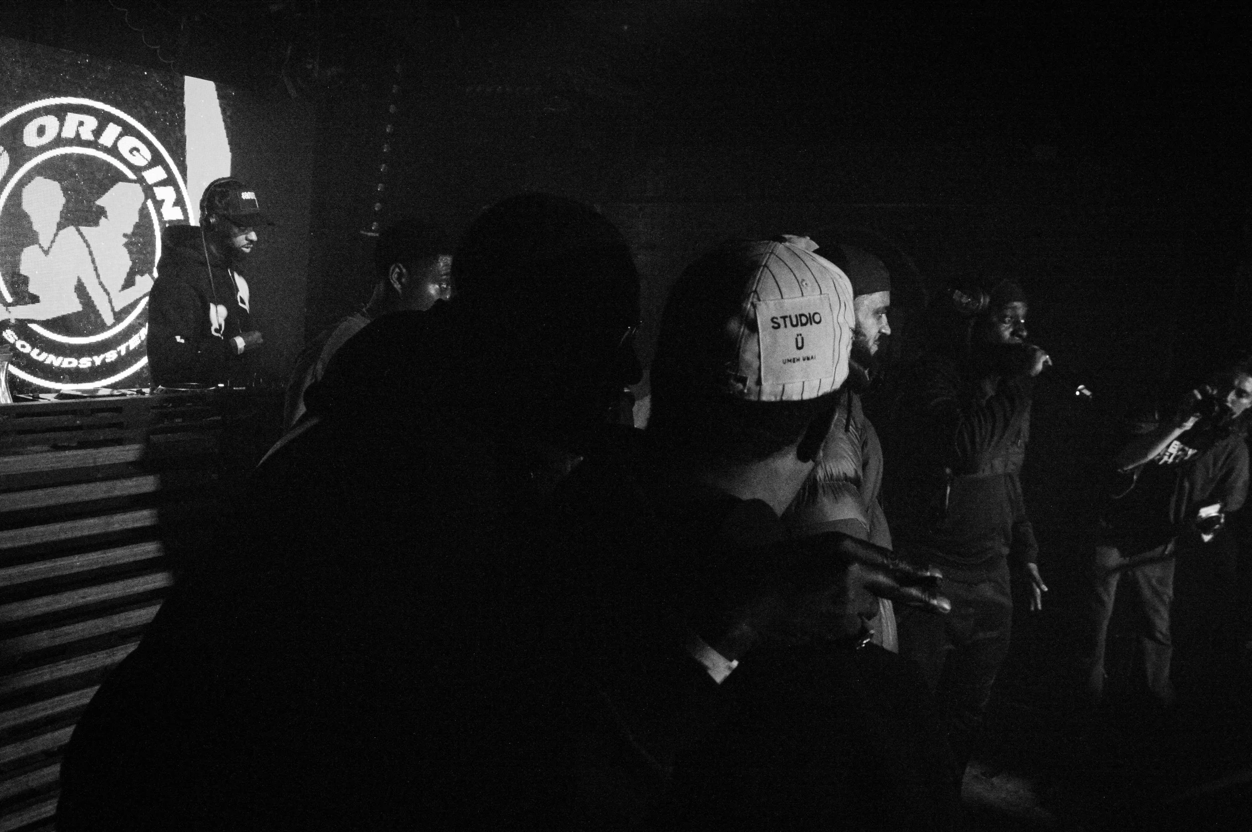 a landscape image of Flowdan with his arm over Manga St Hilaire's shoulders on stage at King Originals rave in Brixton