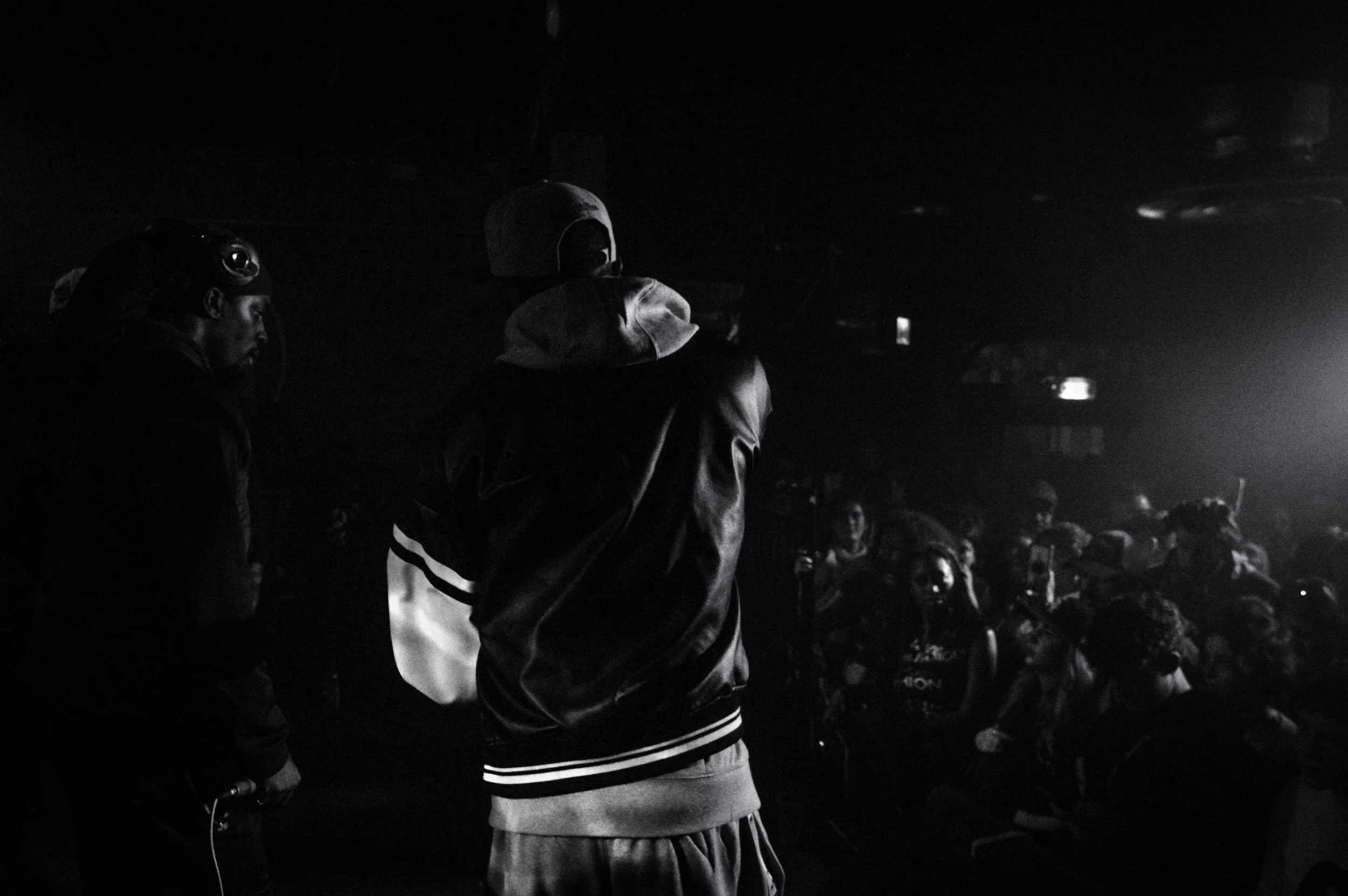 two grime mcs performing on stage at a rave in brixton