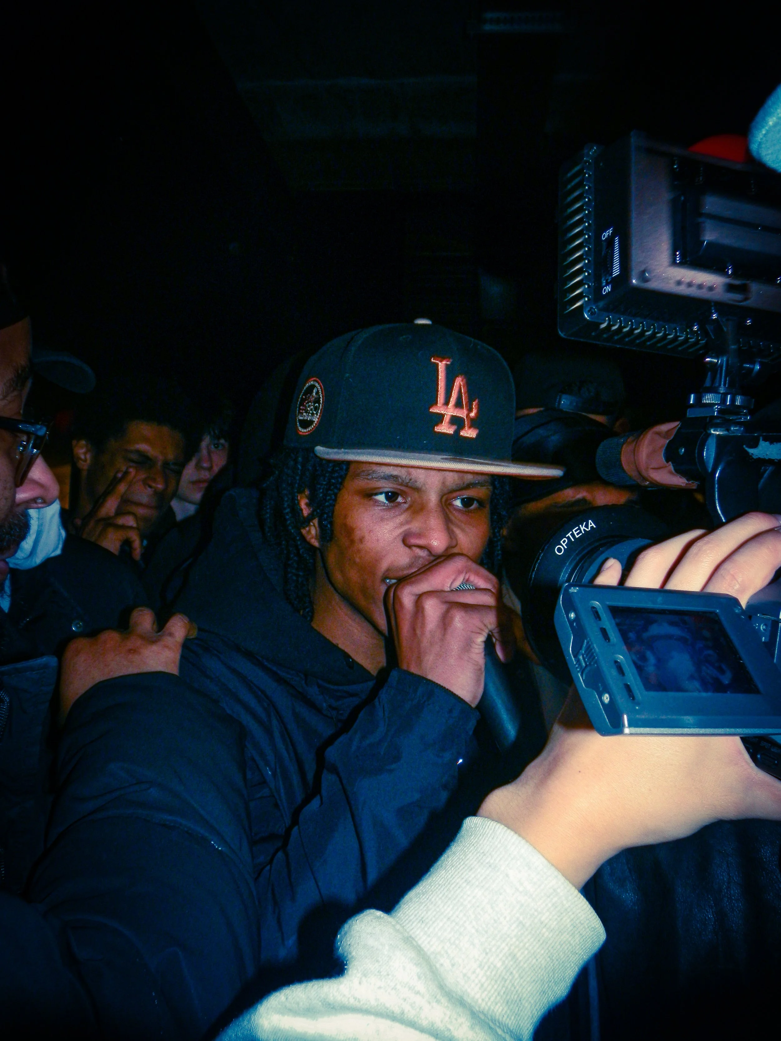 amzzino performing at travspresents grime rave in the middle of a crowd with camcorders in his face