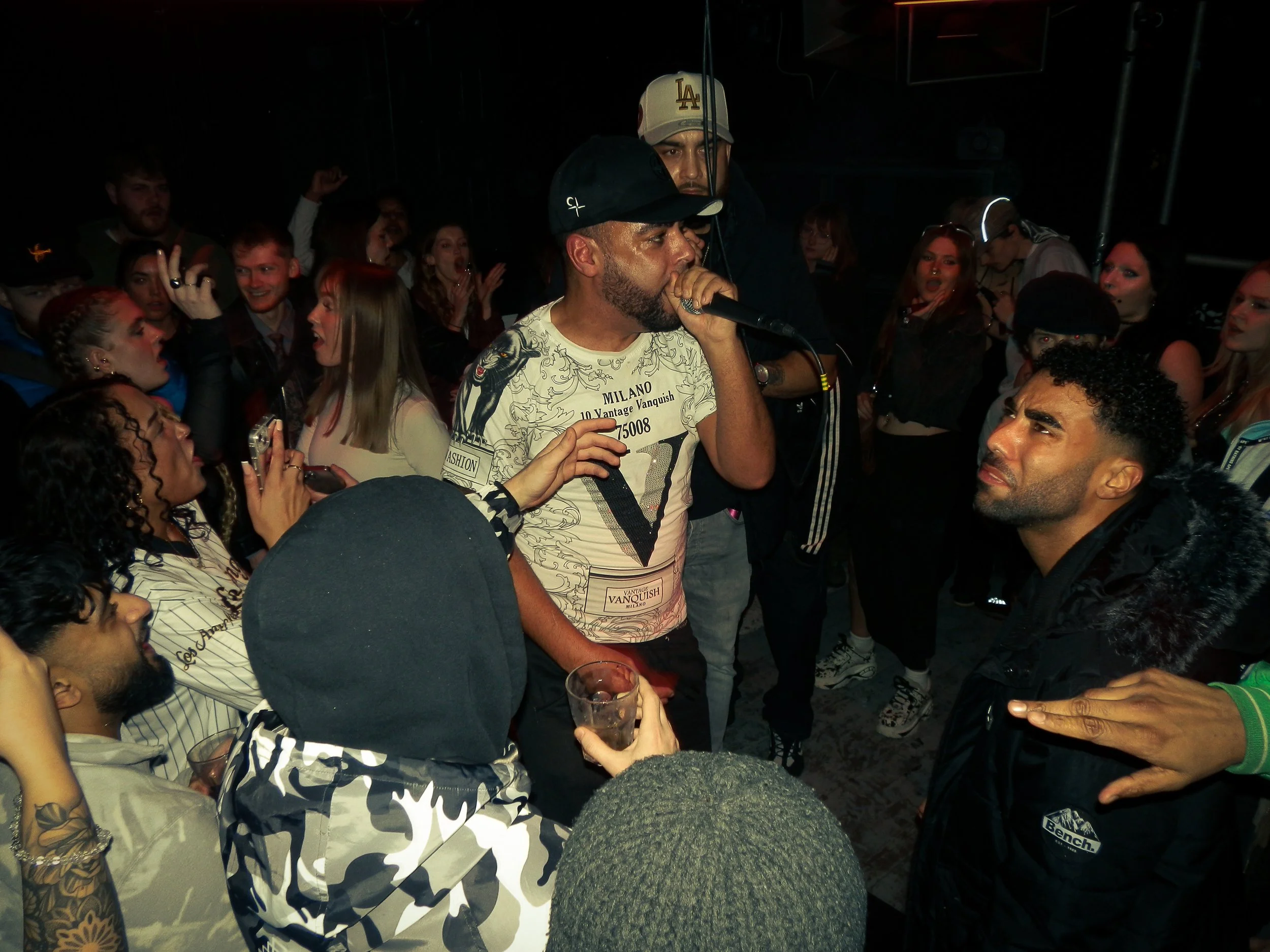 mc performing in the middle of wheel up grime rave 