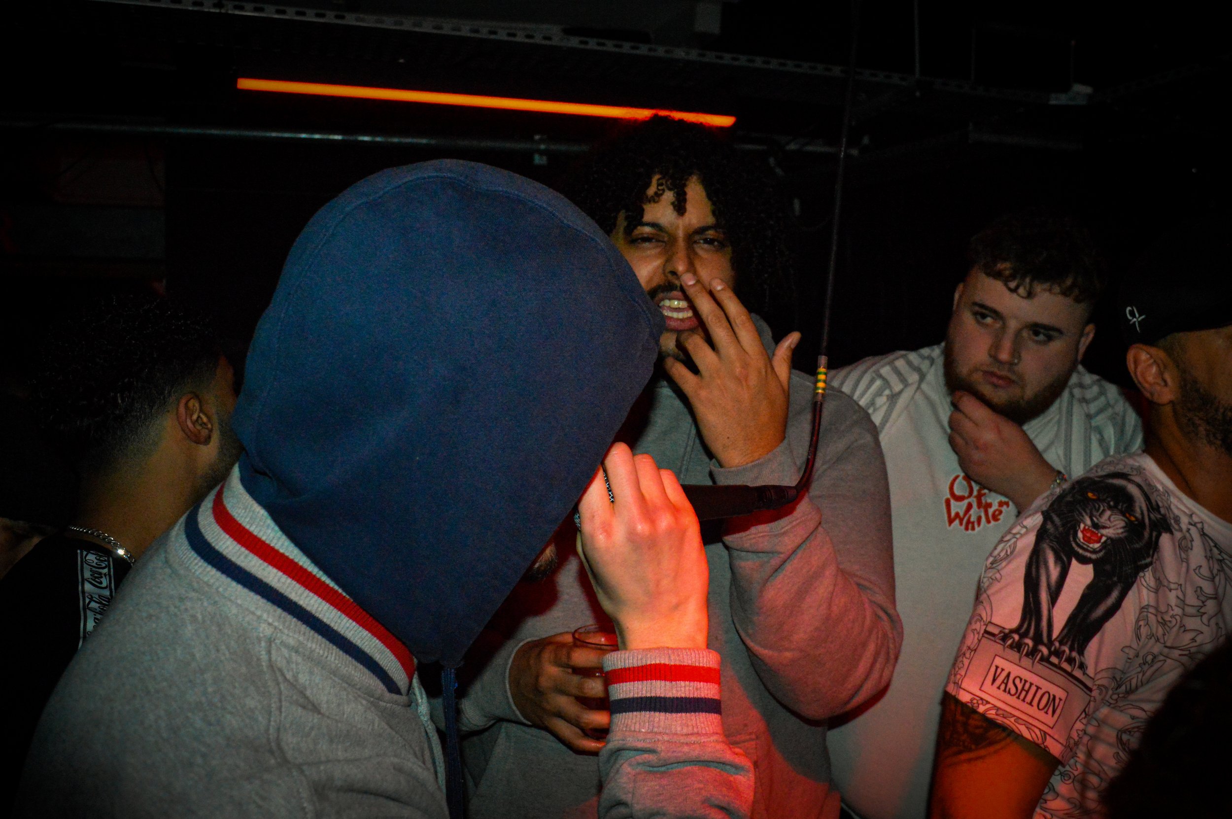 male mcs performing in the middle of a crowd at wheel up grime rave in norwich