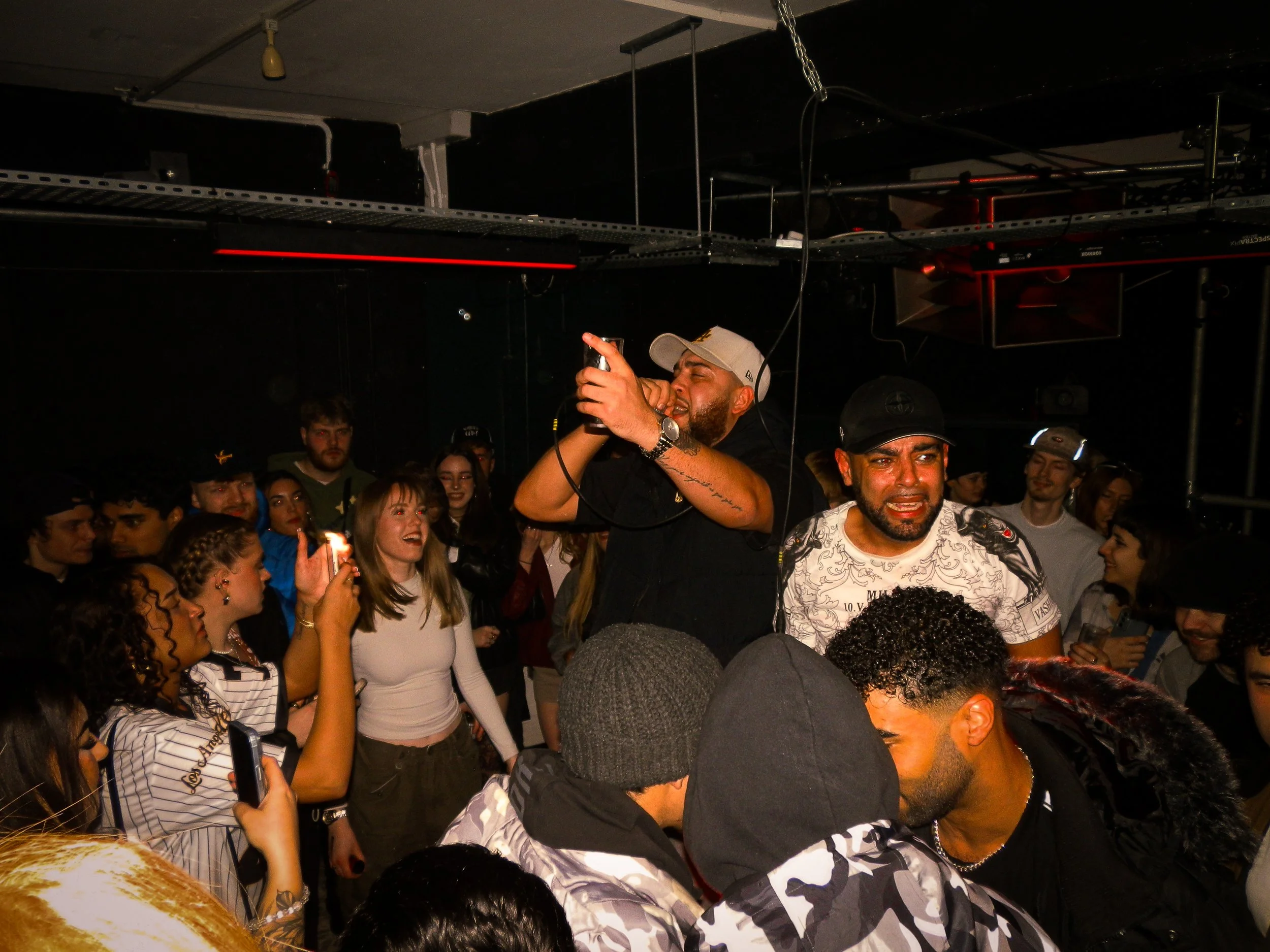 mc performing in the middle of wheel up grime rave 