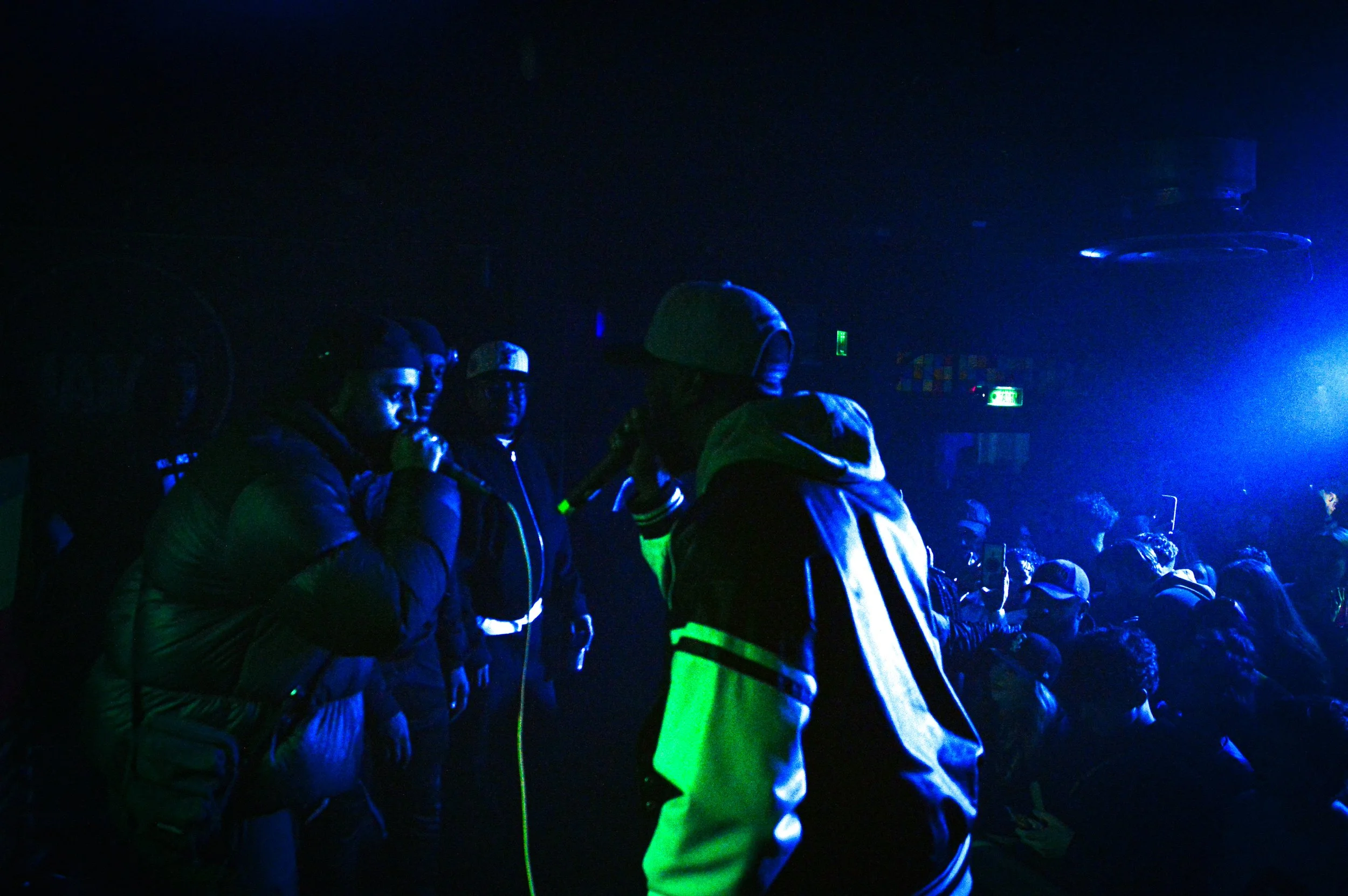two grime mcs performing on stage at a rave in brixton