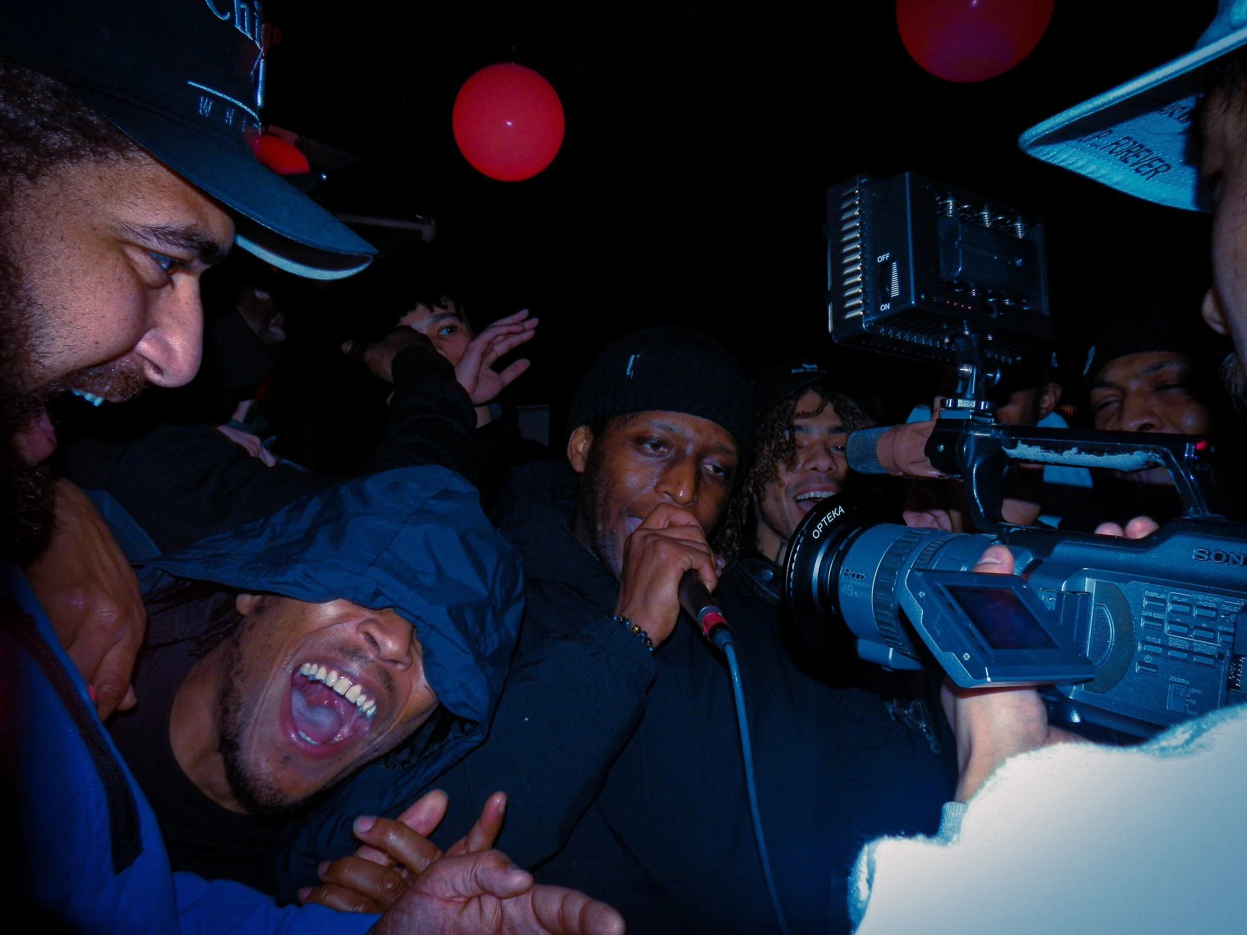 grime musician elf performing into mic and camera at travspresents grime rave London with mercy ace stood next to him