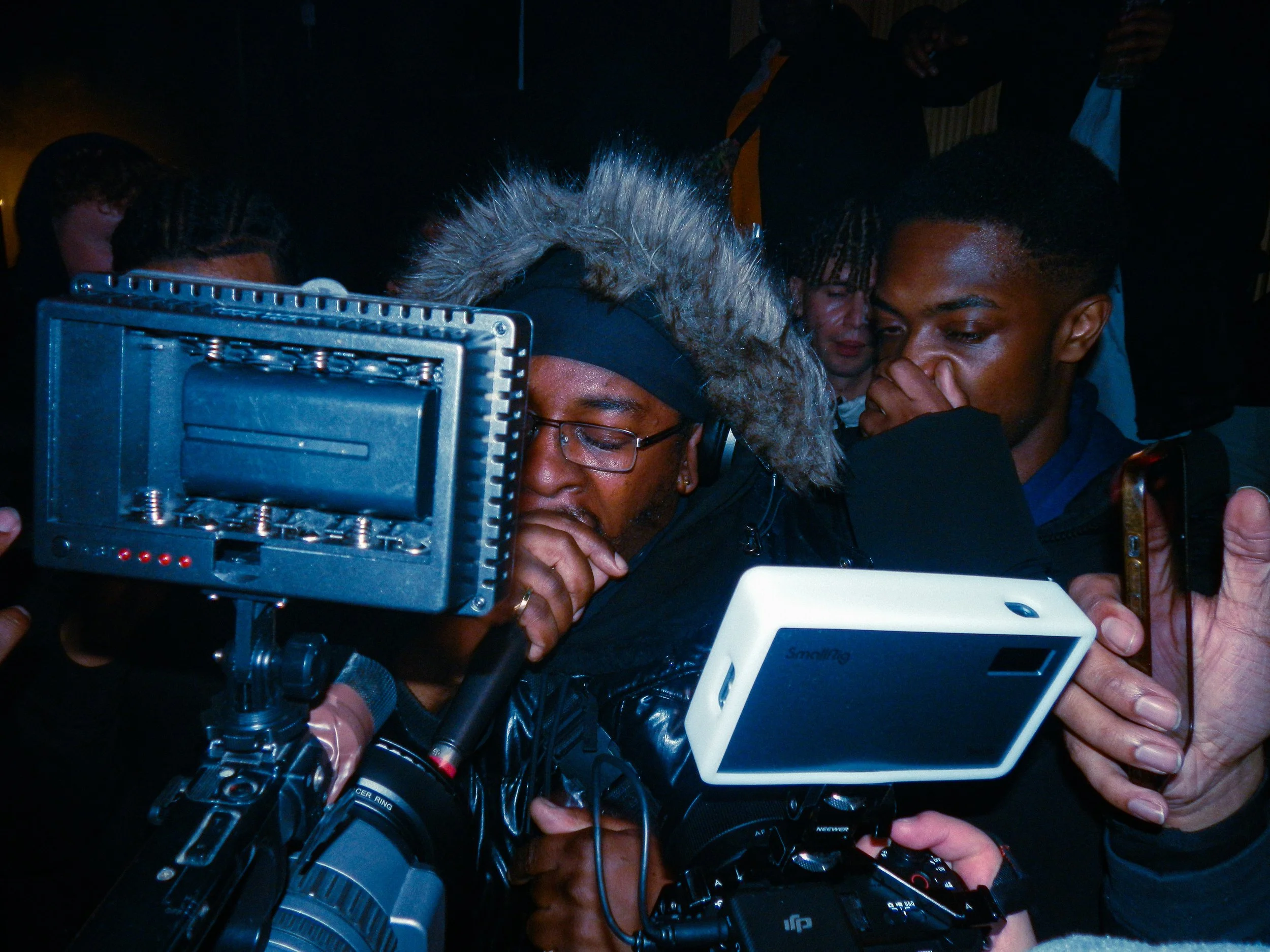Logan olm performing at travspresents grime rave in the middle of a crowd with camcorders in his face