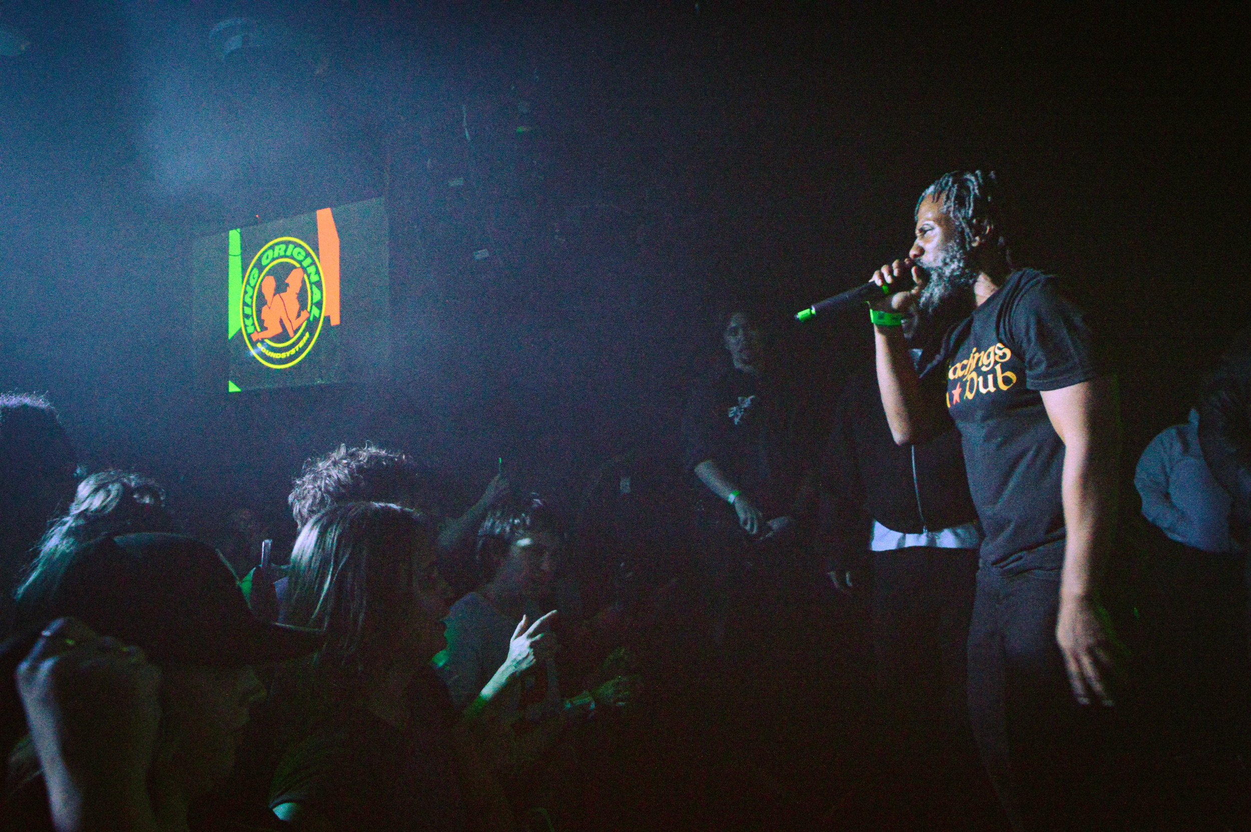 footsie mcing on stage at teaching in dubs rave