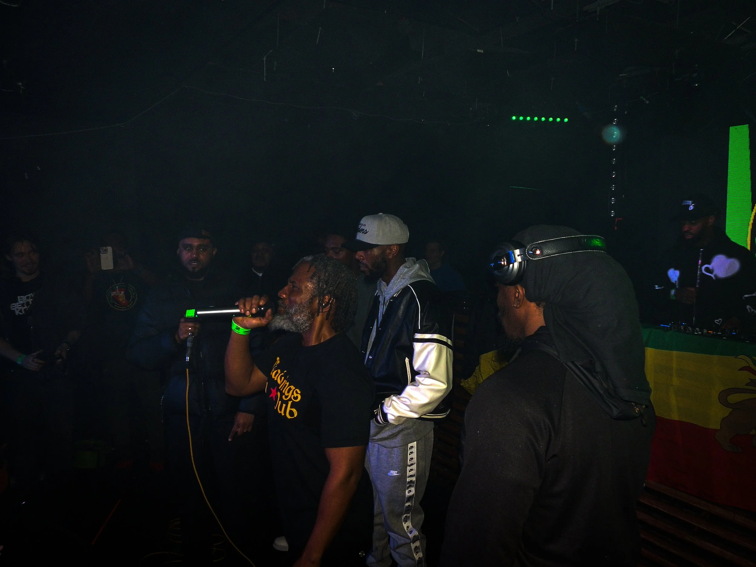 musician footsie mcing with other musicians on stage