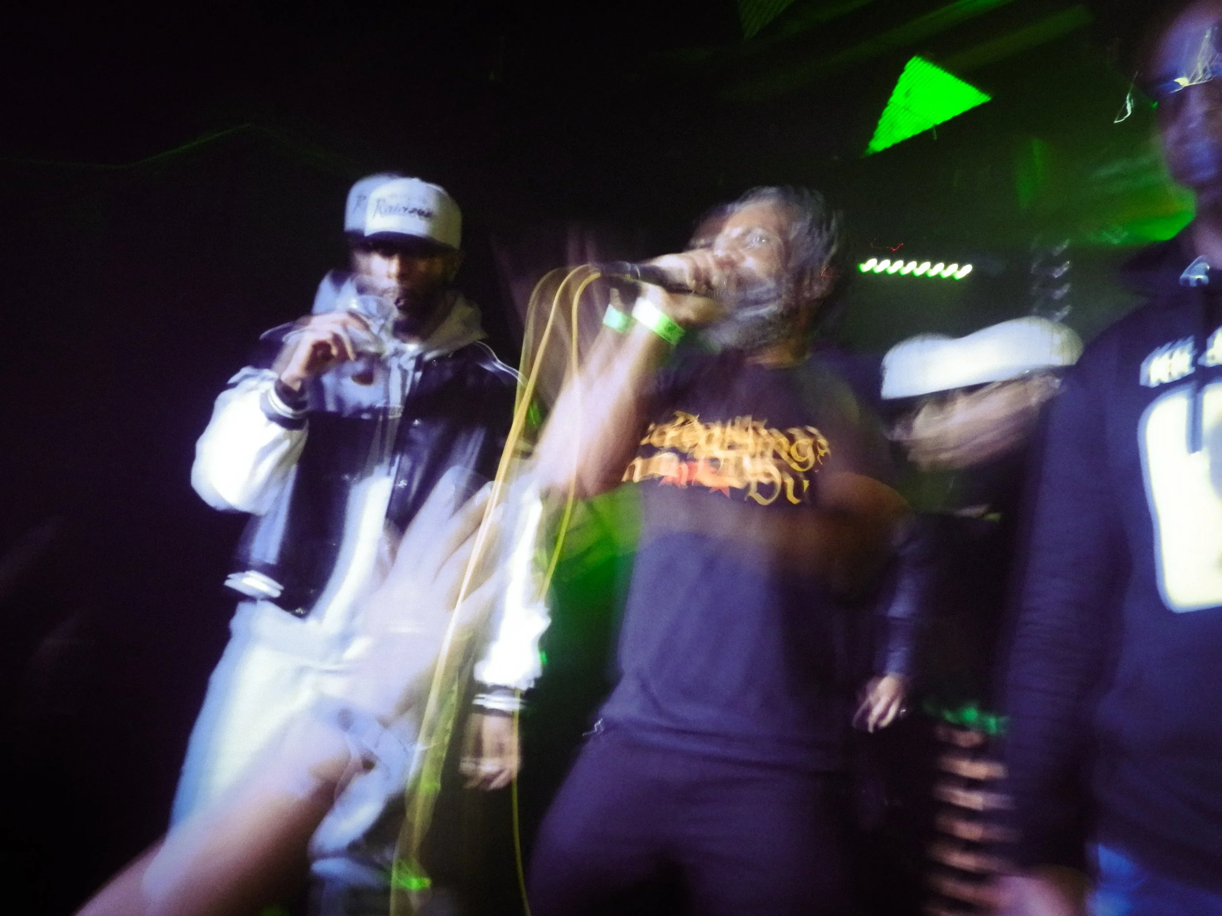 Motion blur photo of footsie and friends mcing on stage 