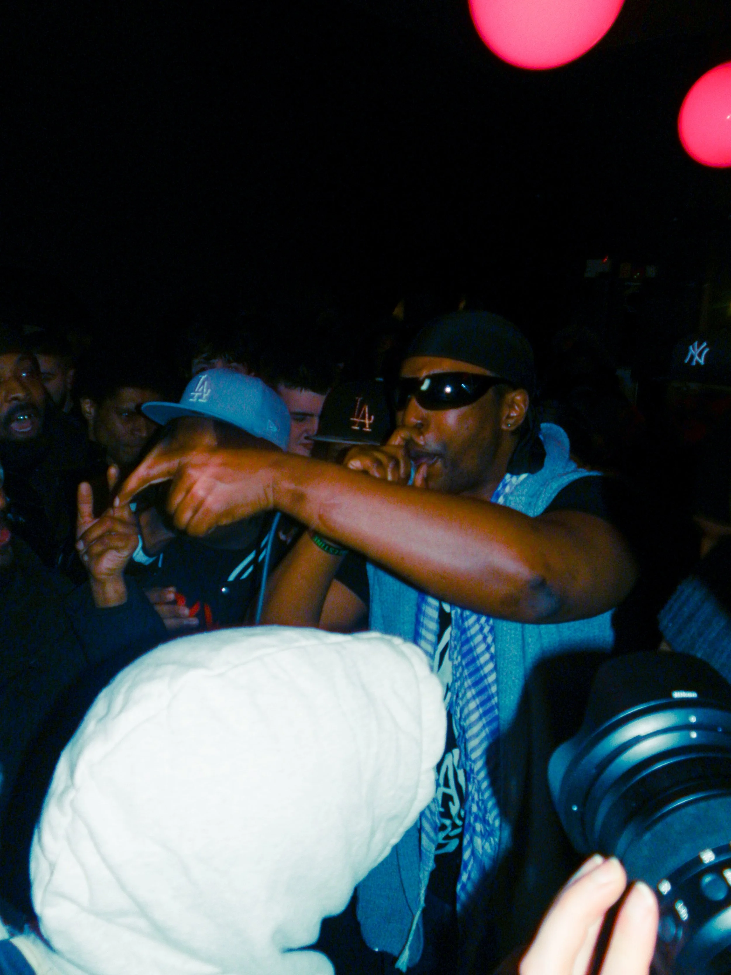M.I.C performing at travspresents grime rave in the middle of a crowd with camcorders in his face