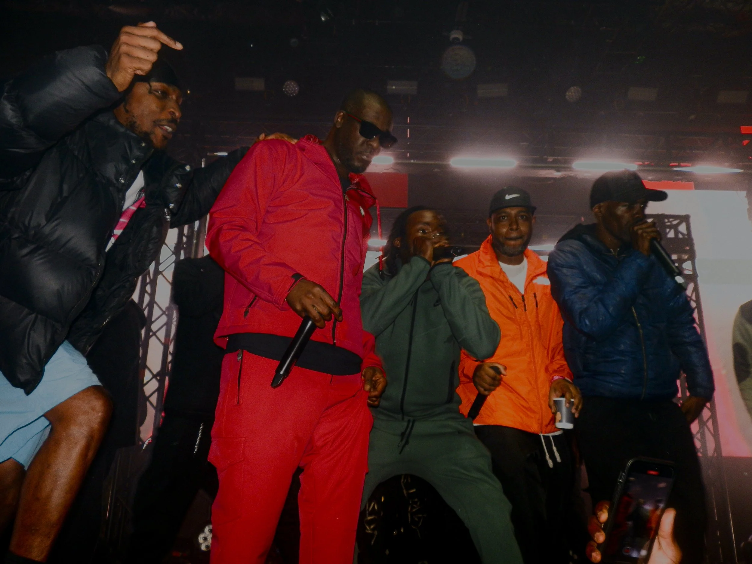 Mcs on stage performing at Lethal Bizzle's Pow 20 year anniversary show