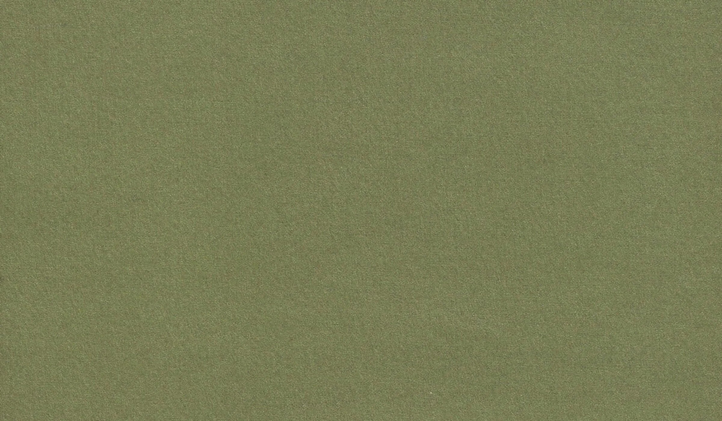 A modern white house nestled among dense green trees and shrubs on a hillside, with solar panels on nearby structures in the background.