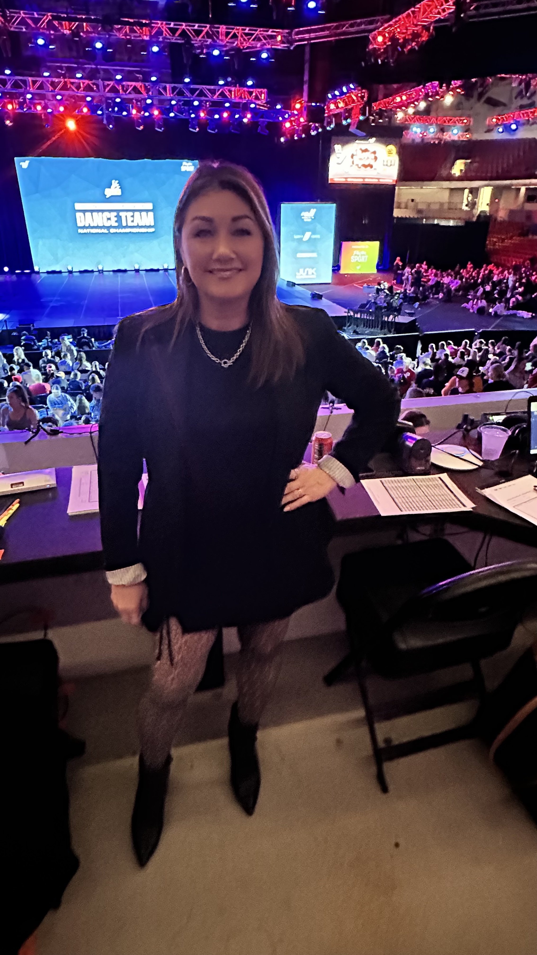 Sarah Schneeweis judging dance competitions and providing expert feedback for dancers at national dance events